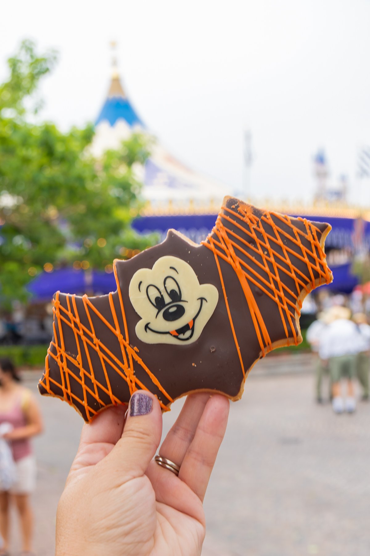 Mickey bat cookie being held by a hand