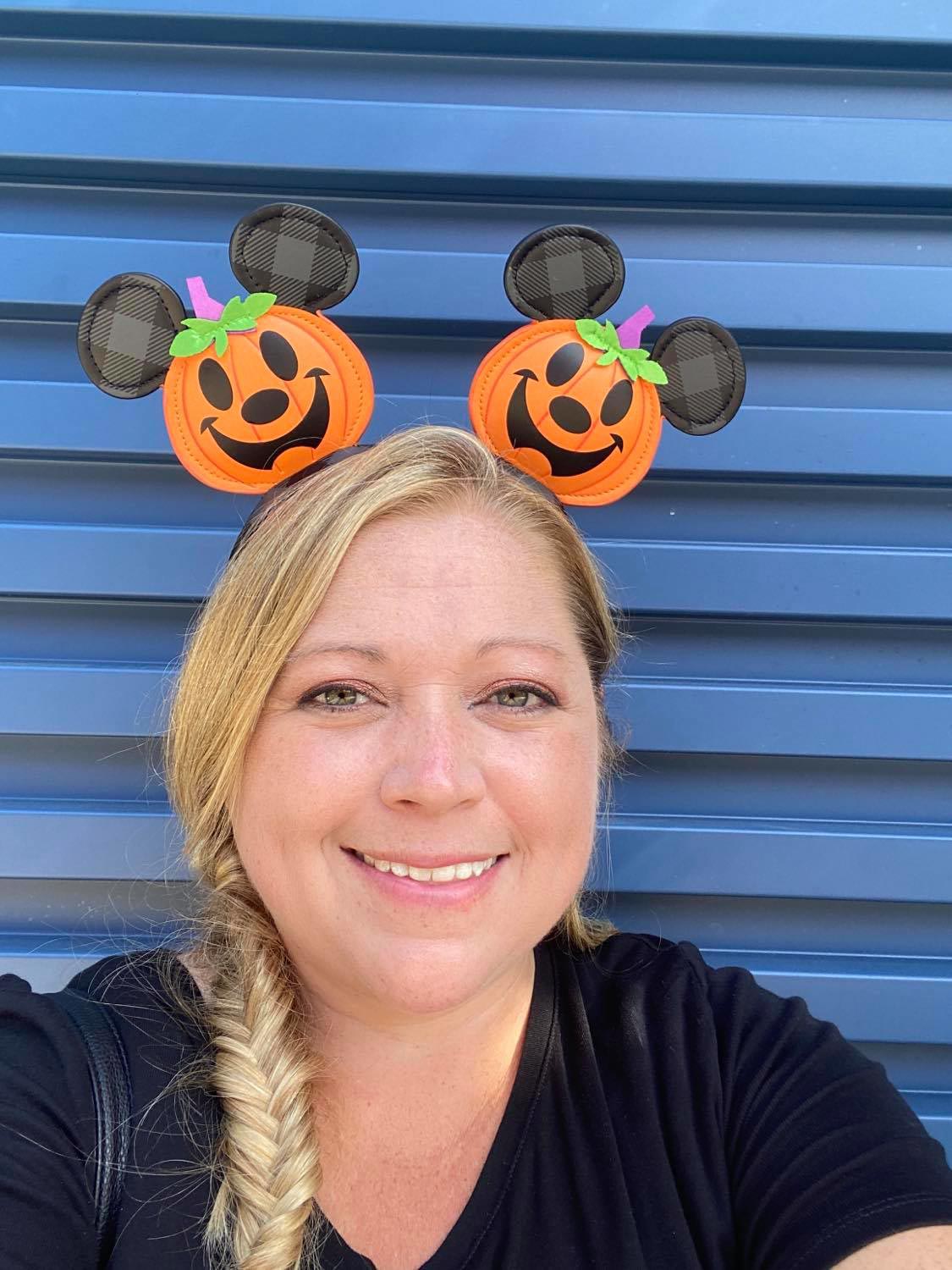 Woman in pumpkin Mickey ears