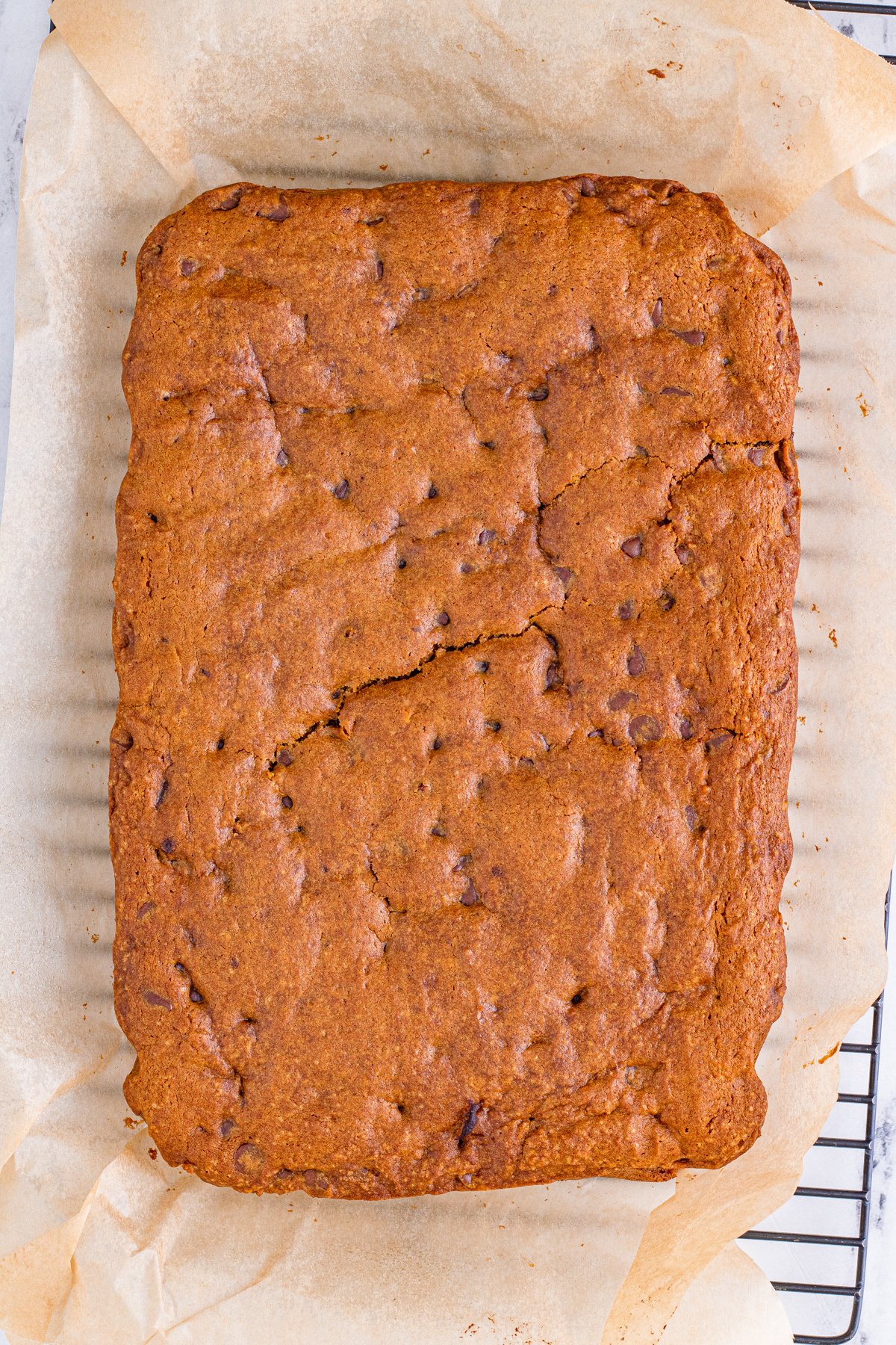 baked pumpkin blondies on a piece of parchment paper