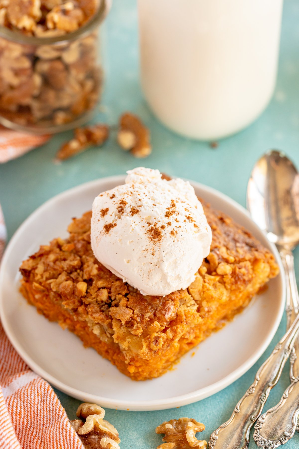 a piece of pumpkin crunch cake with whipped cream