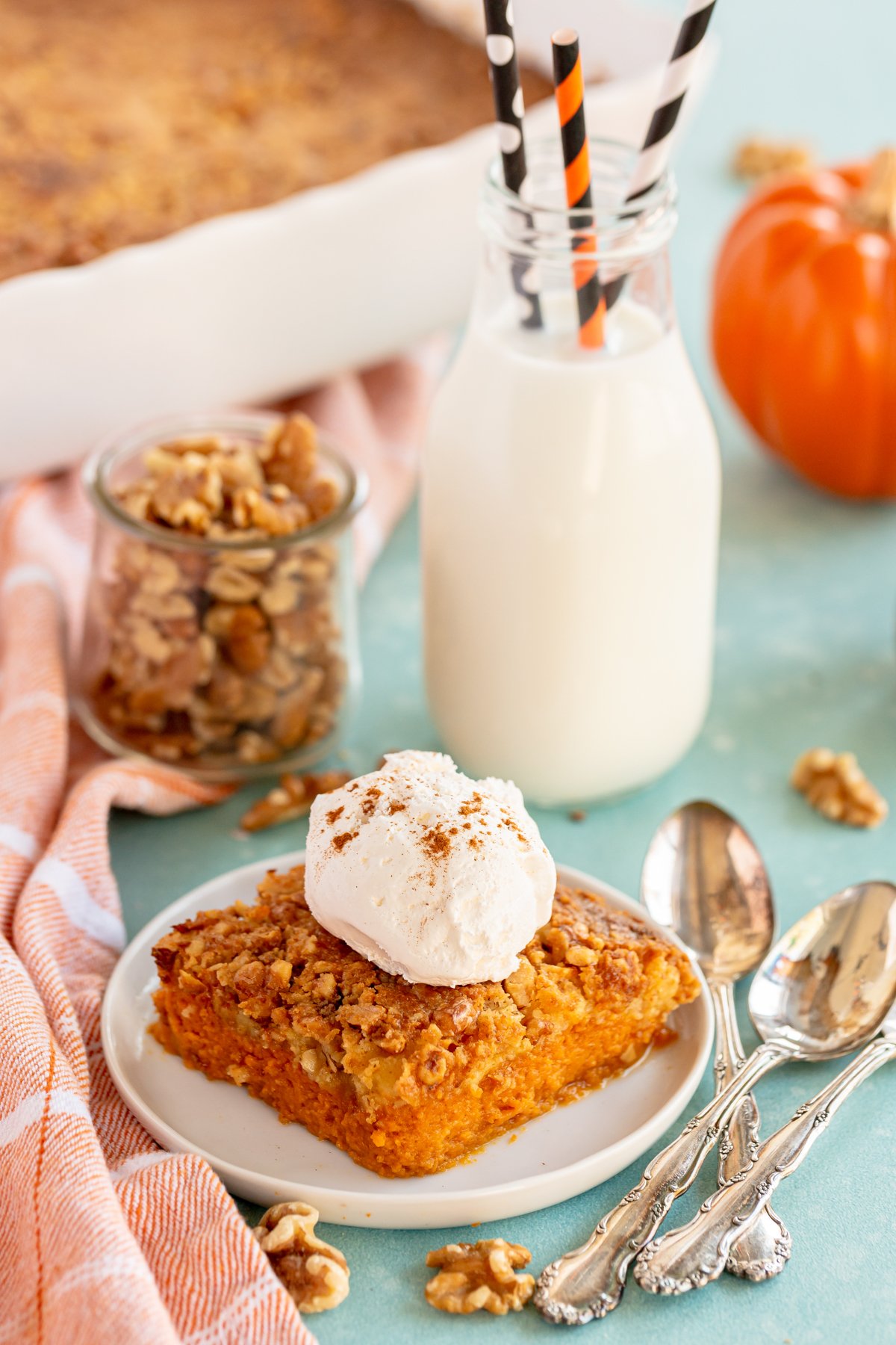 piece of pumpkin crunch cake with milk in the background