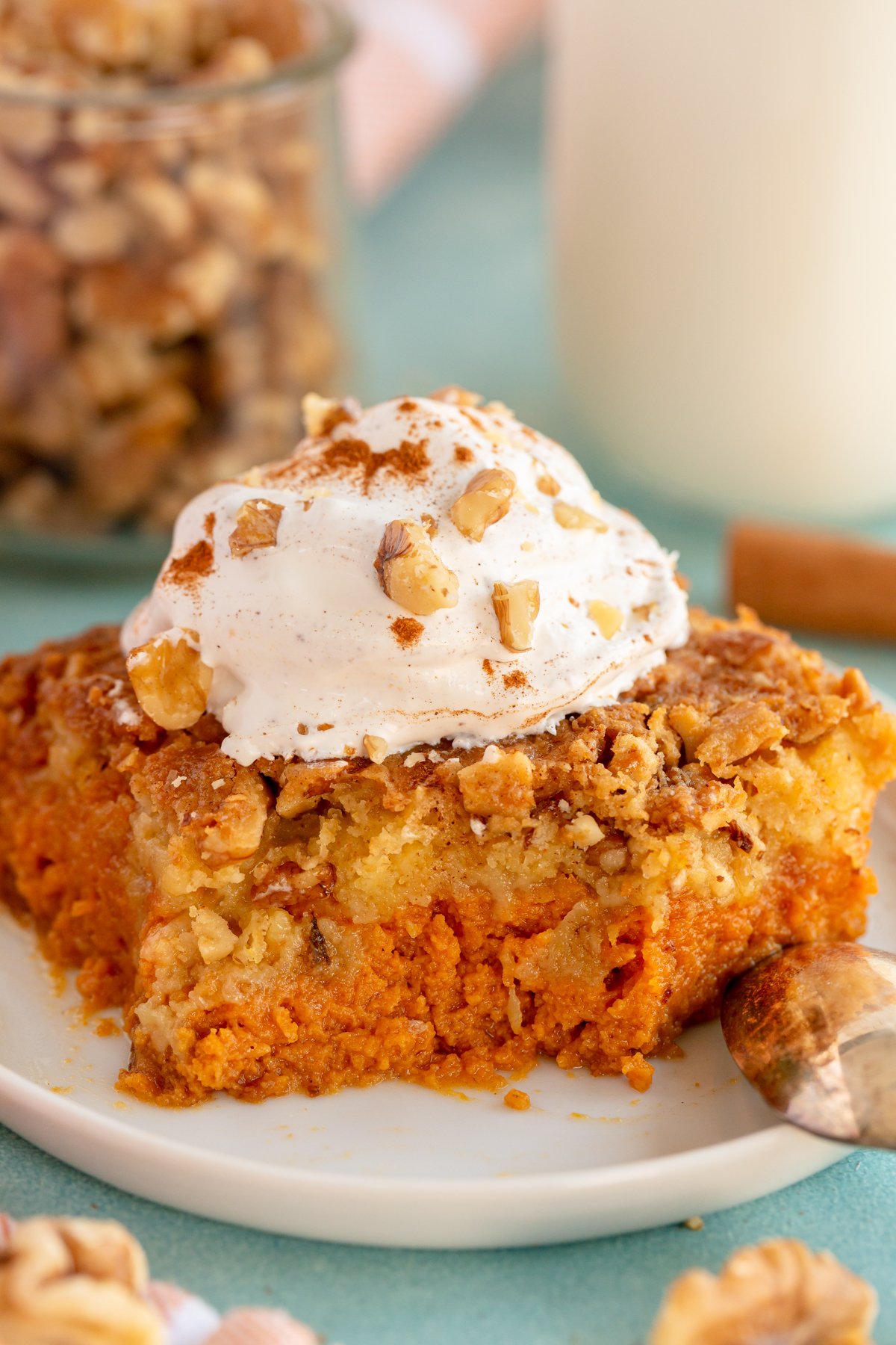 piece of pumpkin crunch cake with whipped cream on top