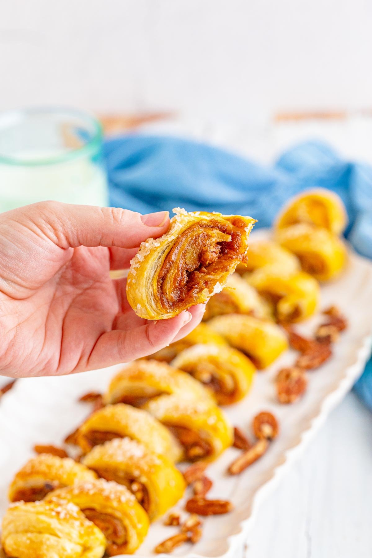 hand holding a piece of pumpkin pull apart bread