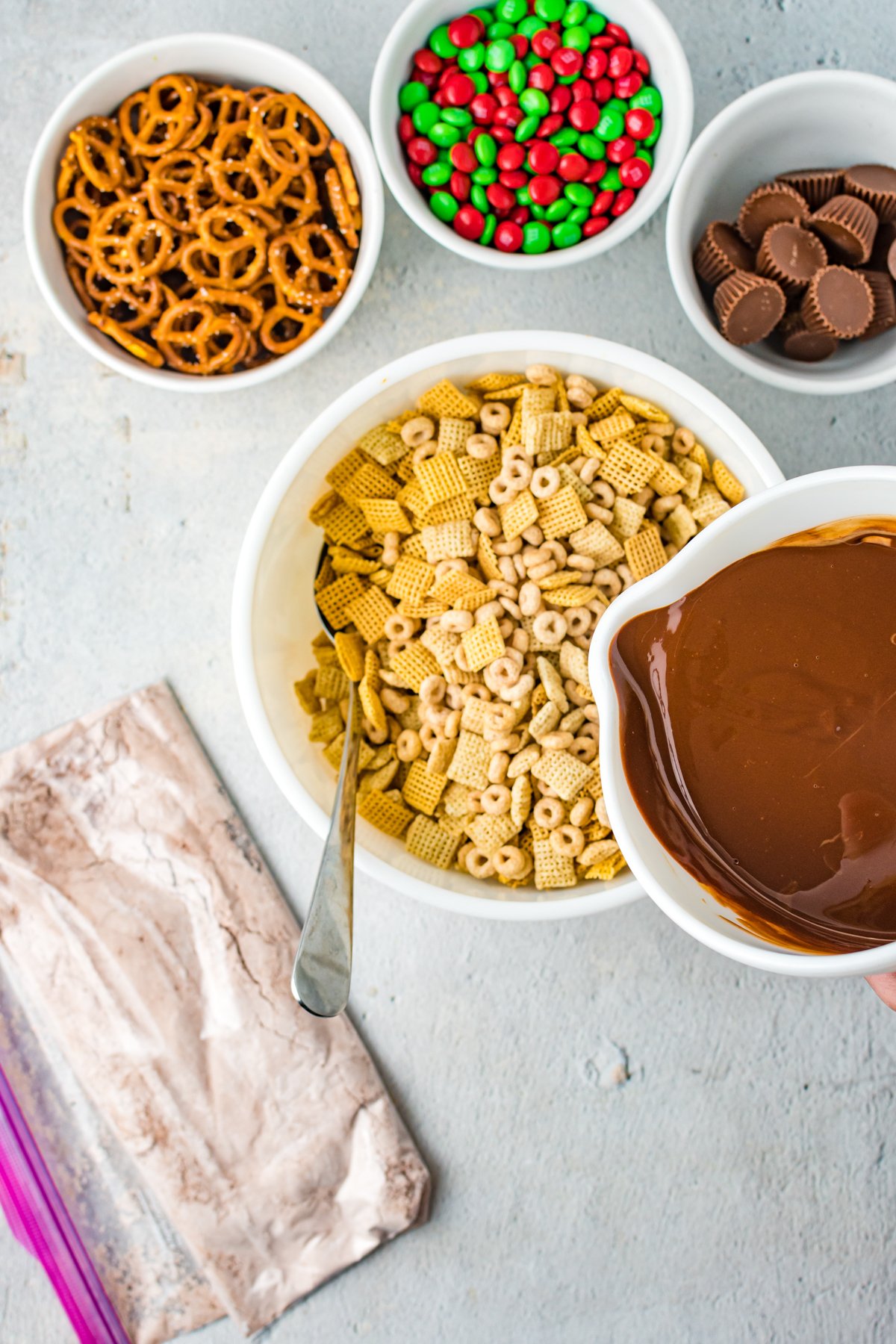 pouring melted chocolate over cereal