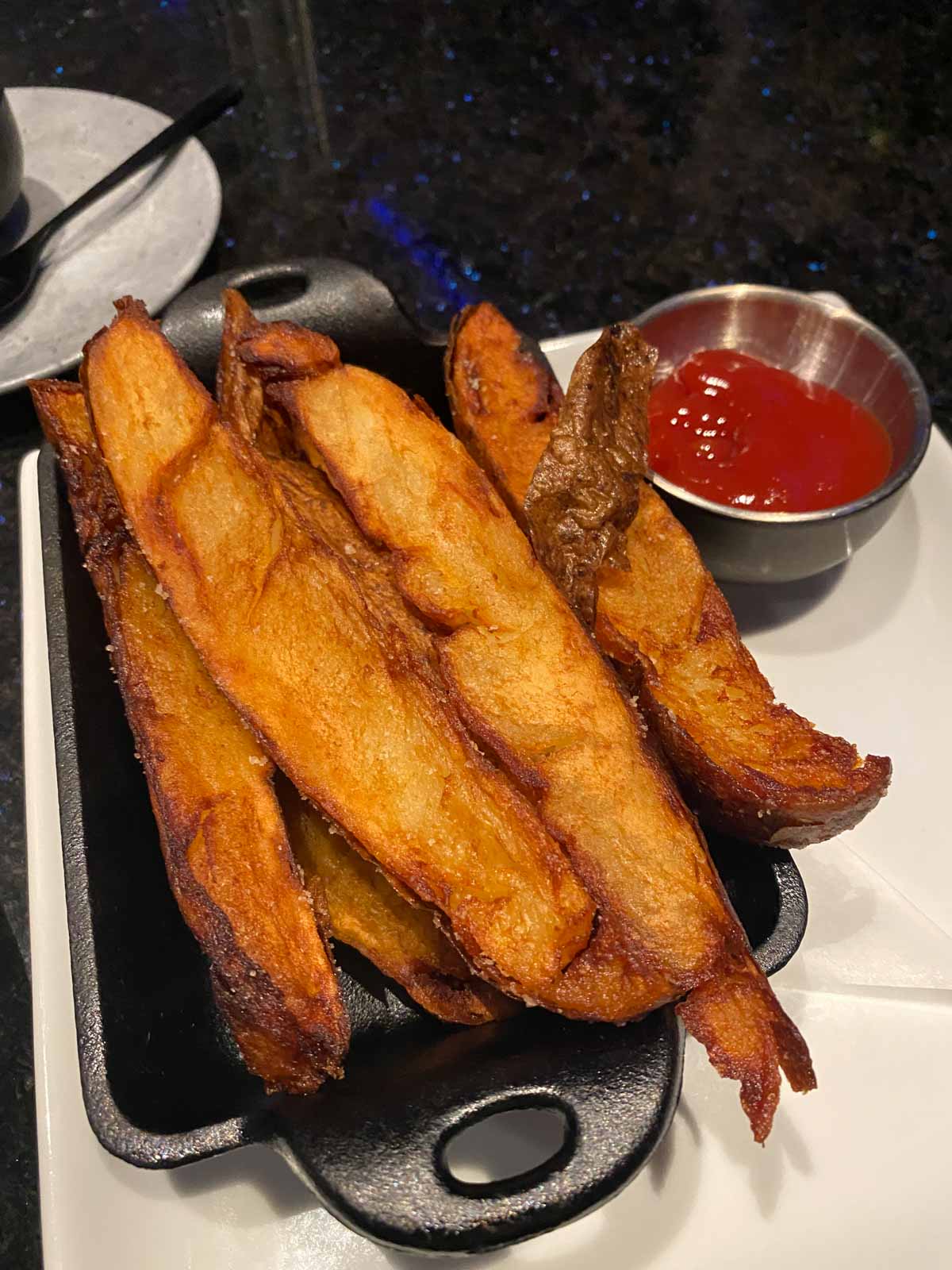 potato wedges in a cast iron dish at Space 220