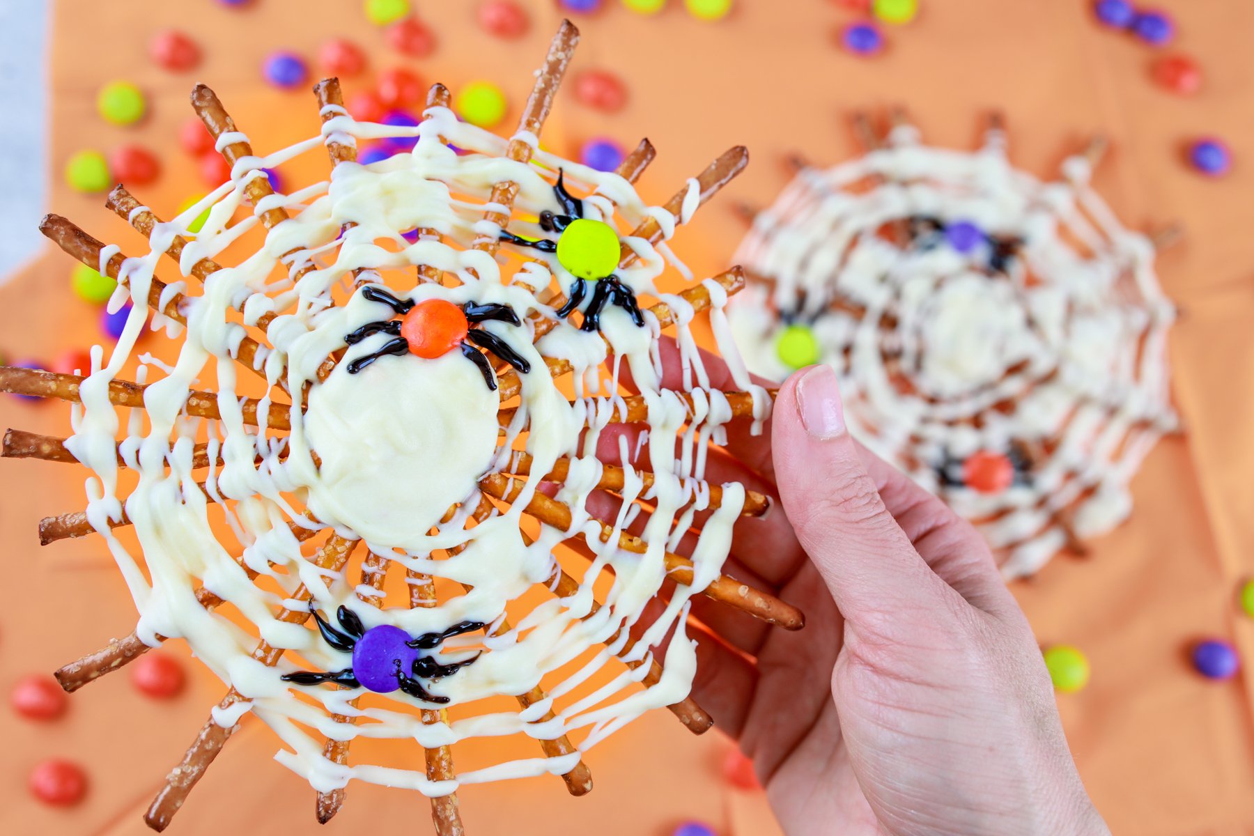 pretzel spider webs on an orange background