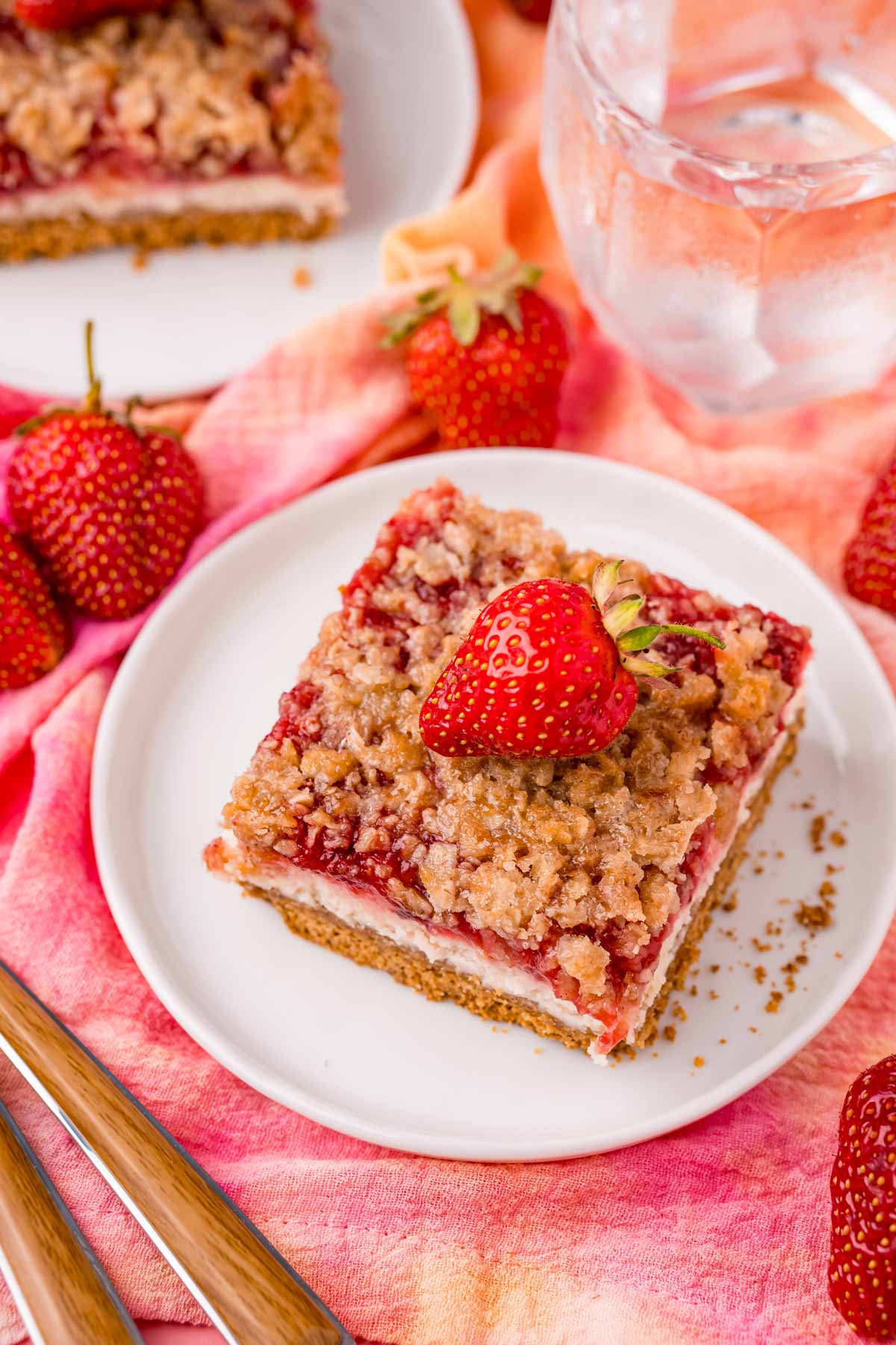 top down view of a strawberry cheesecake bar on a white plate