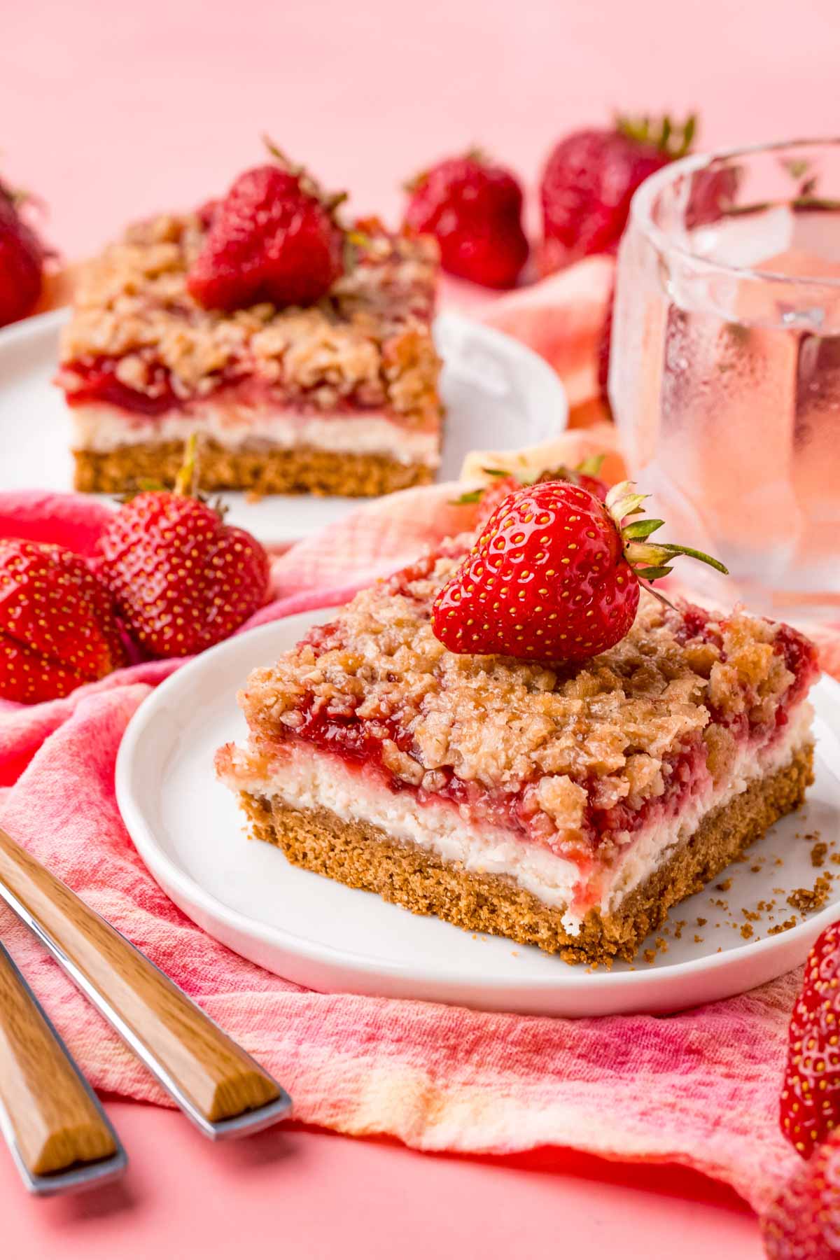 a strawberry cheesecake bar on a white plate