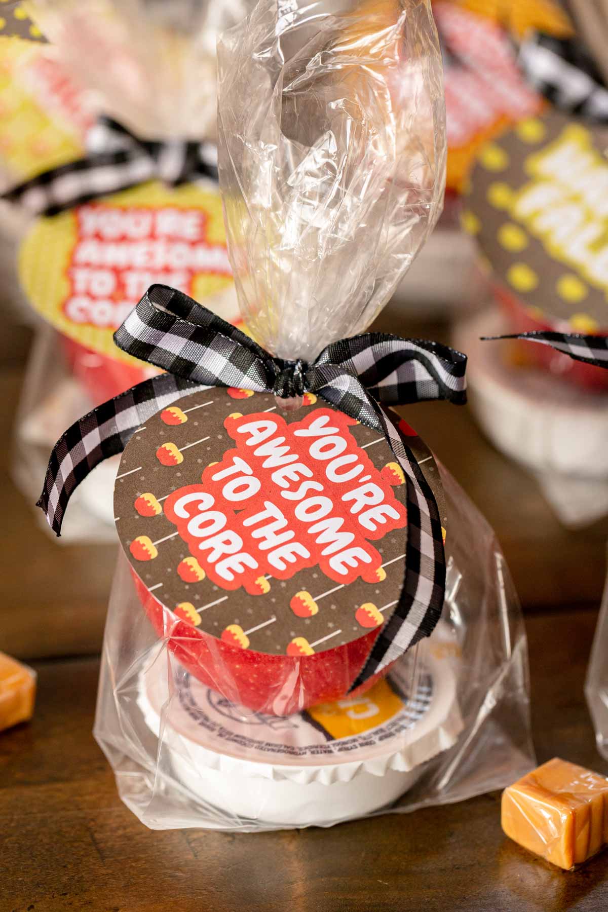 caramel and apple in a bag with a tag