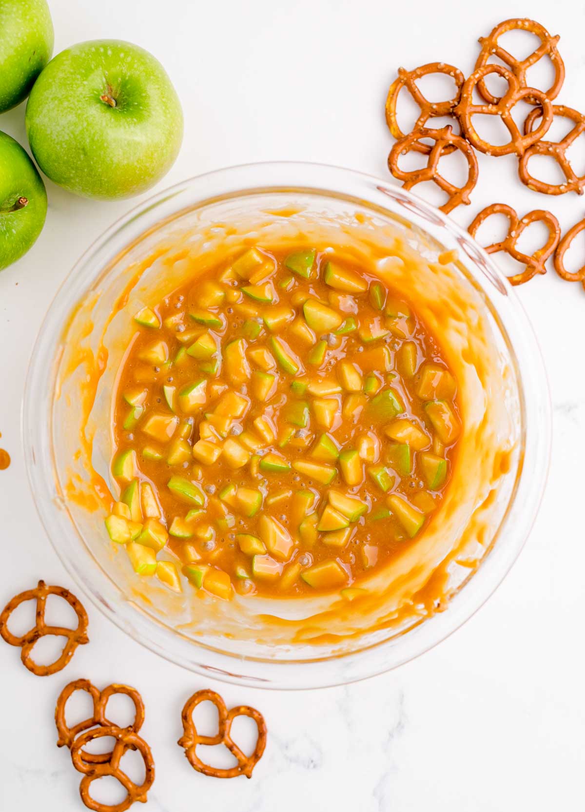 diced apples in a bowl of caramel