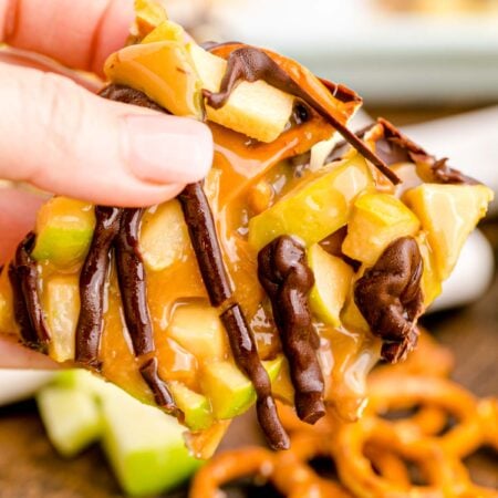 hand holding a piece of caramel apple bark