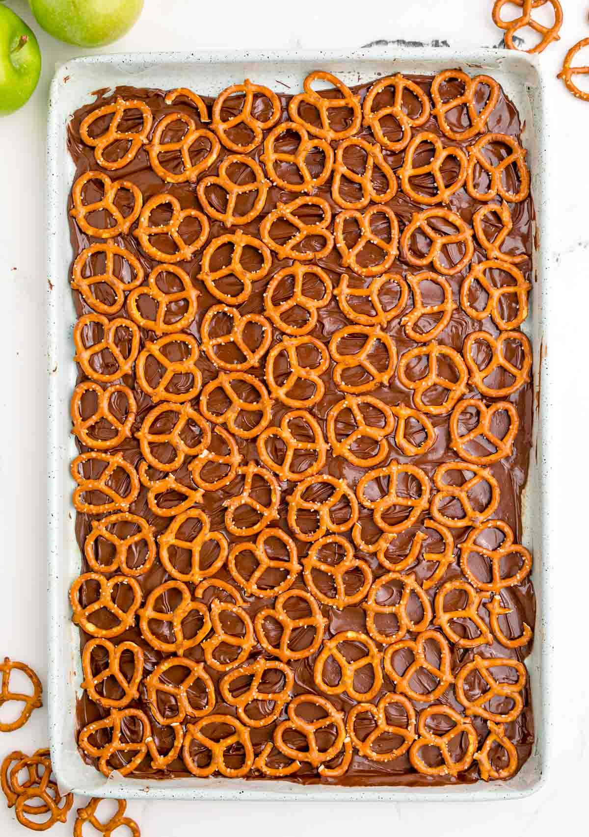 melted chocolate topped with pretzels