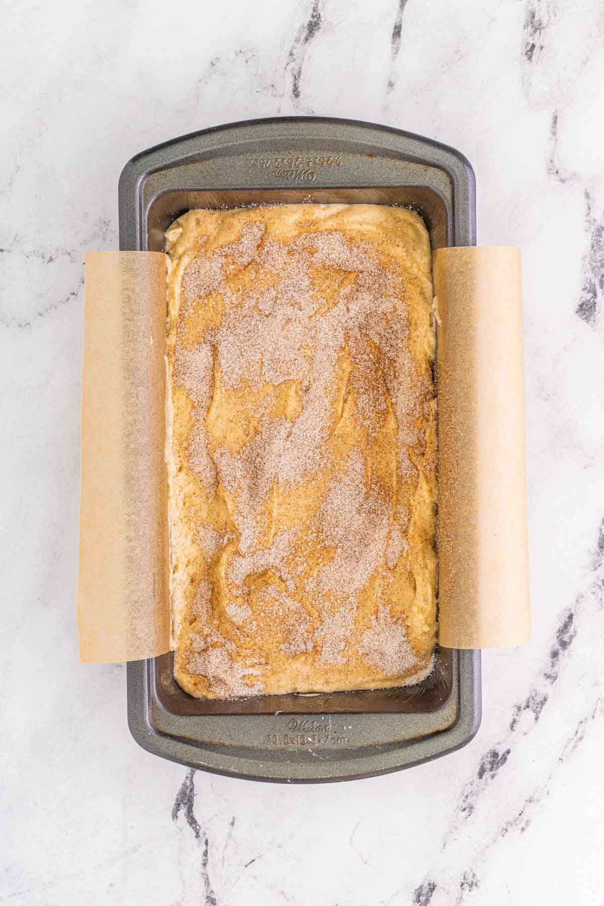 cinnamon swirl bread batter in a metal baking pan