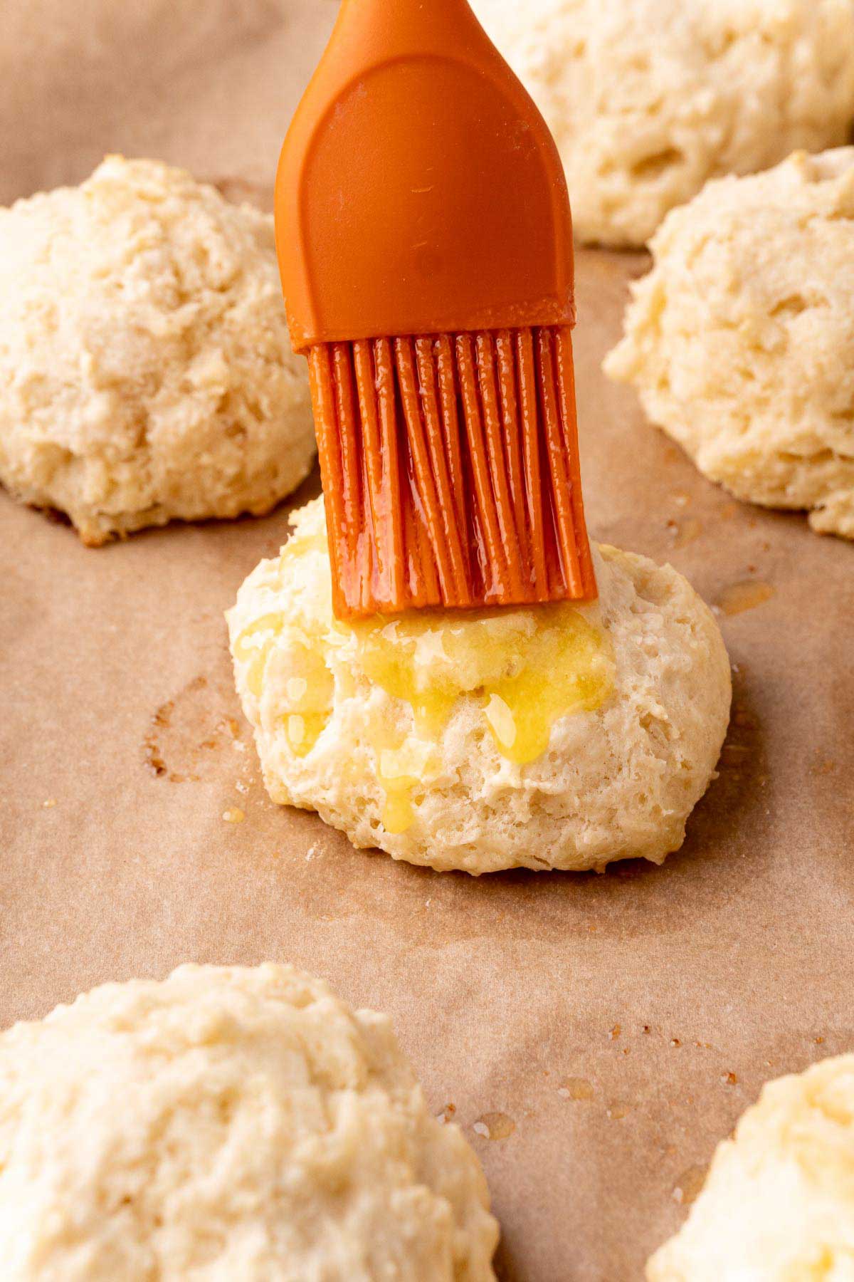 brushing butter onto drop biscuits