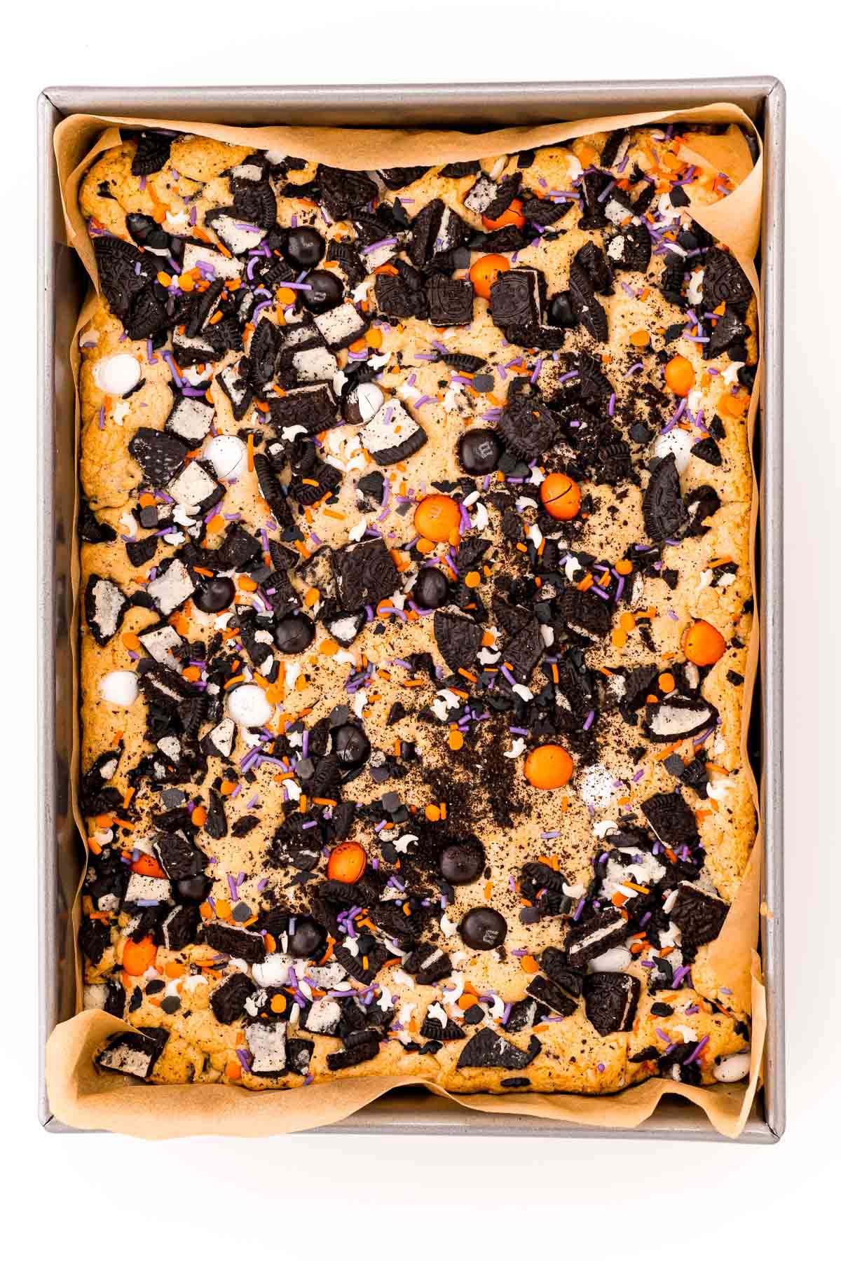 baked Halloween M&M cookie bars in a pan