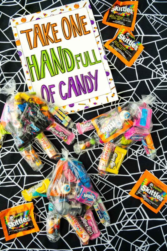 plastic gloves with candy and a Halloween candy bowl sign