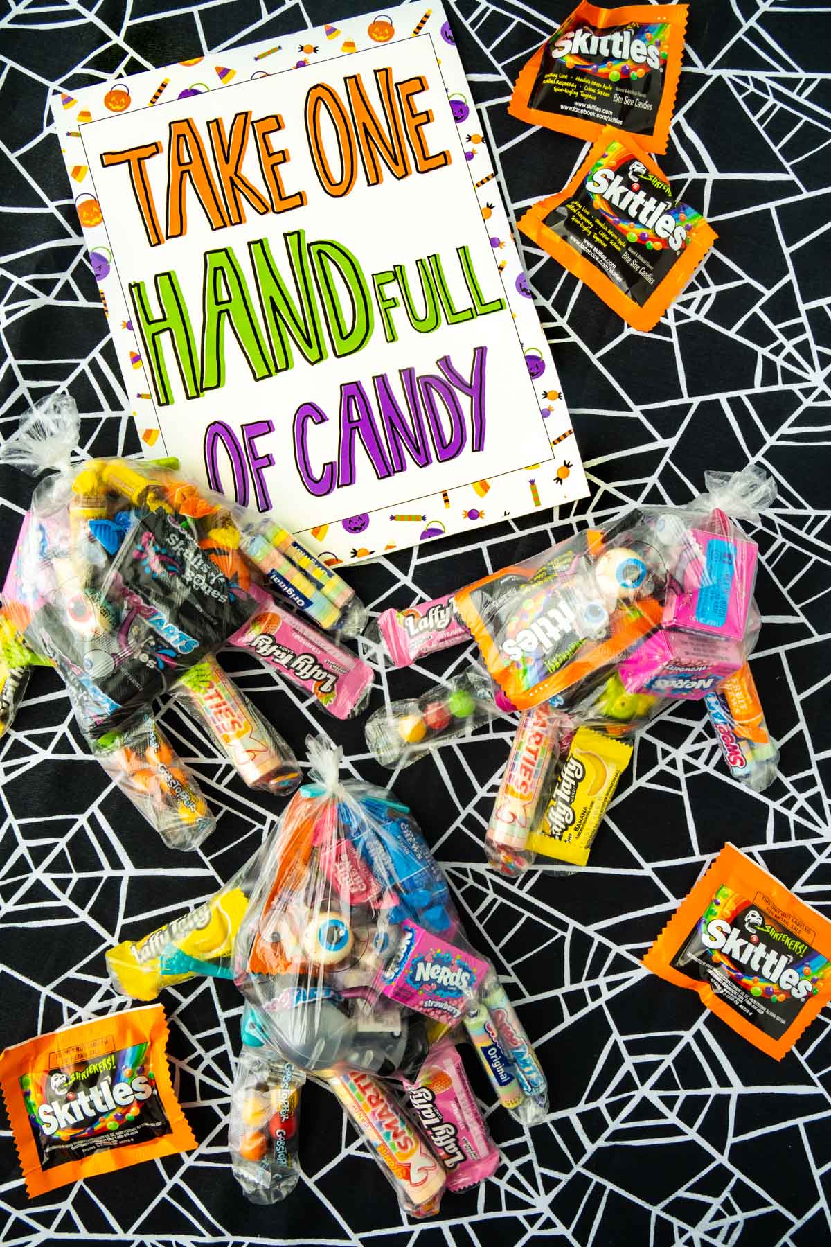 plastic gloves with candy and a Halloween candy bowl sign