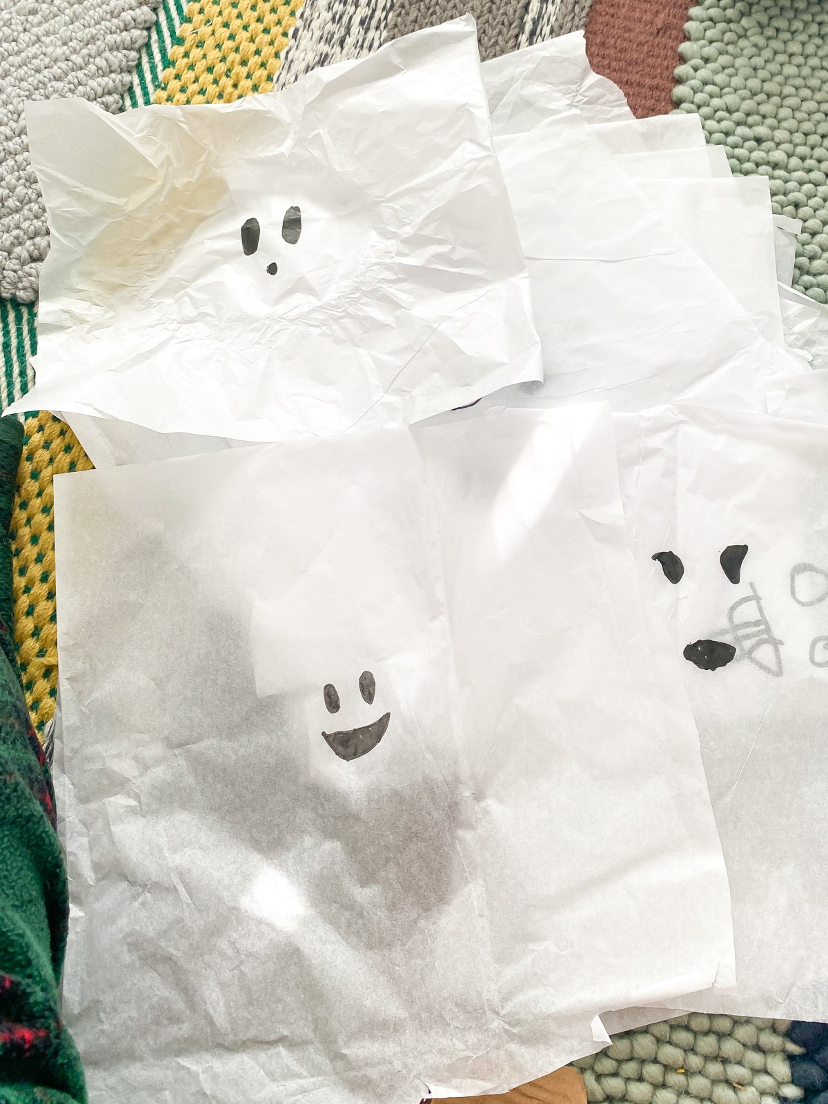 ghost faces drawn on tissue paper