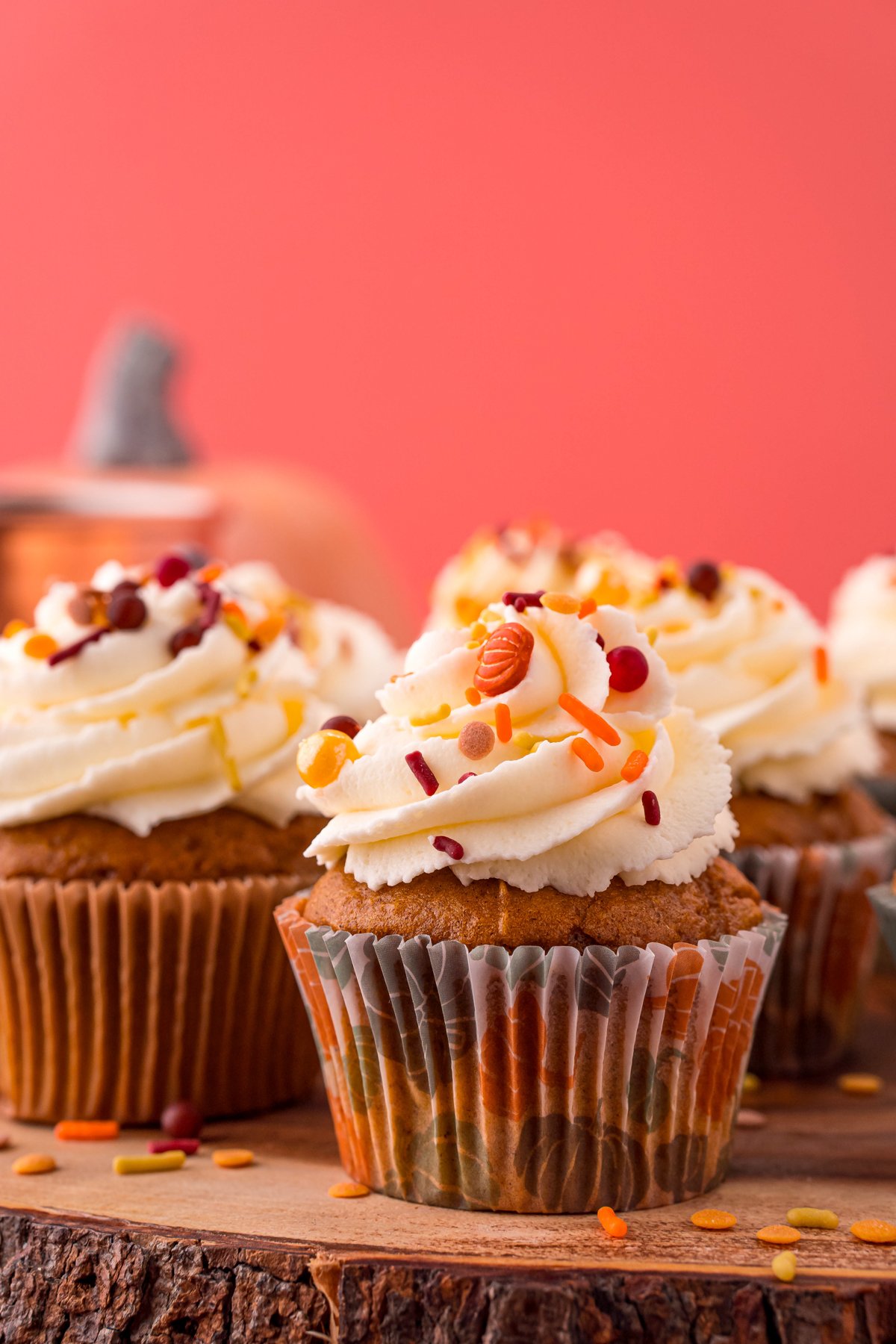 pumpkin cupcakes on a wood cake stand