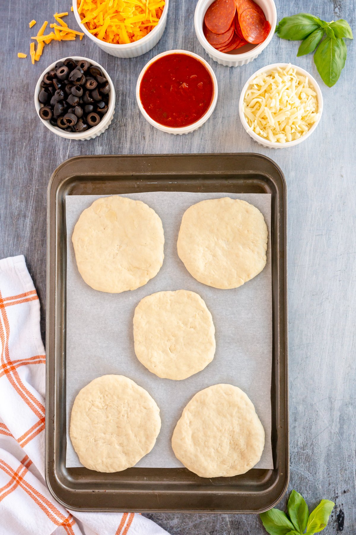 mini pizza dough circles on a baking sheet