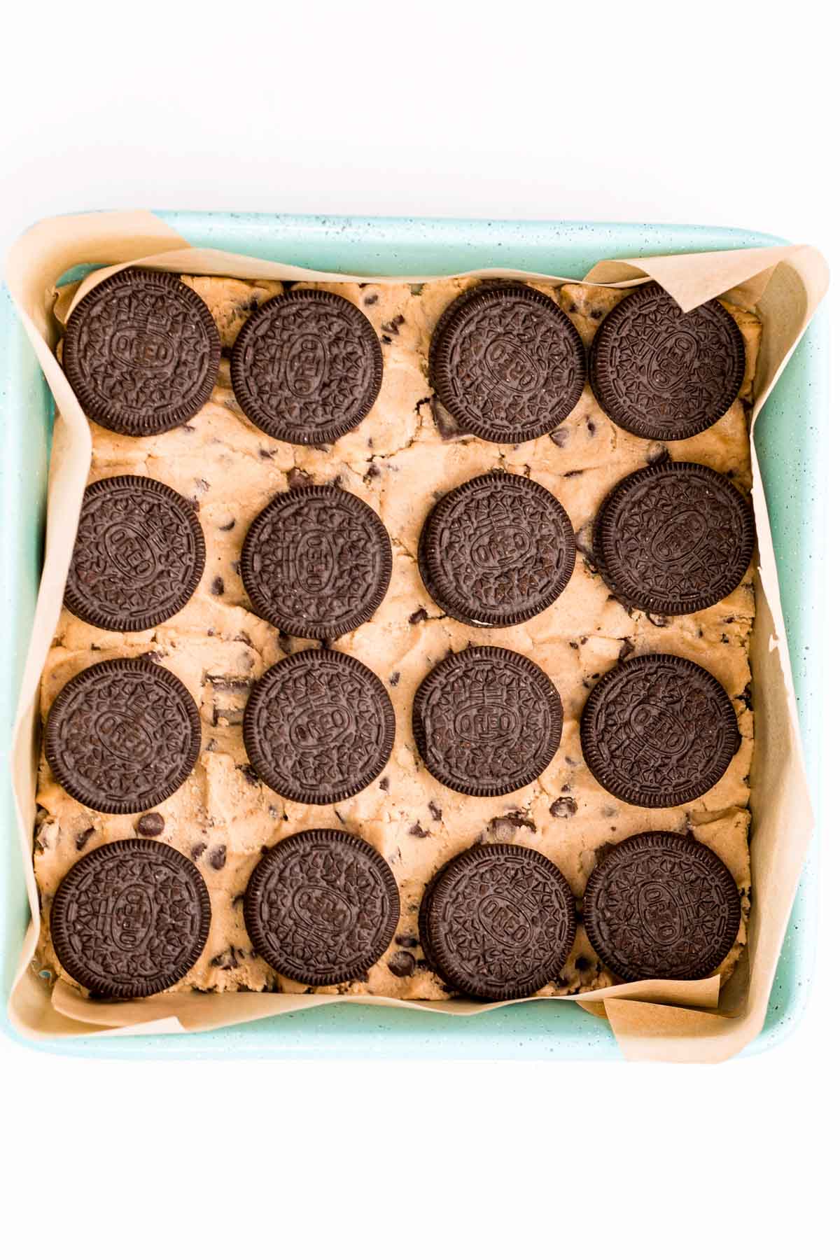 Oreos on cookie dough in a baking dish