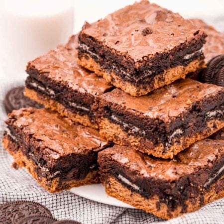 stack of slutty brownies on a white plate