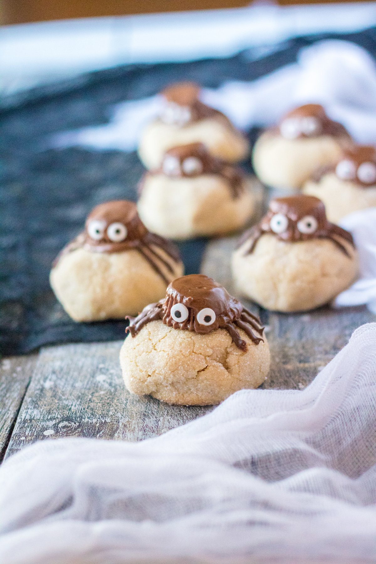 peanut butter spider cookies with a spider web tablecloth