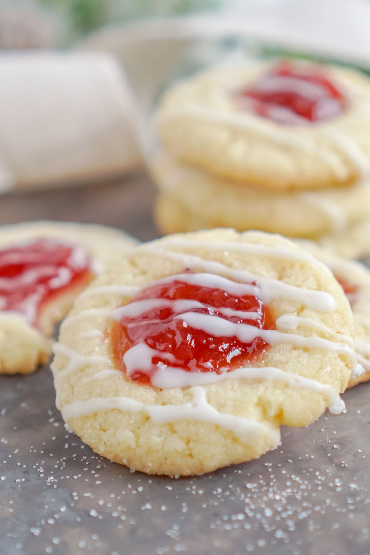 strawberry thumbprint cookie on a baking sheet