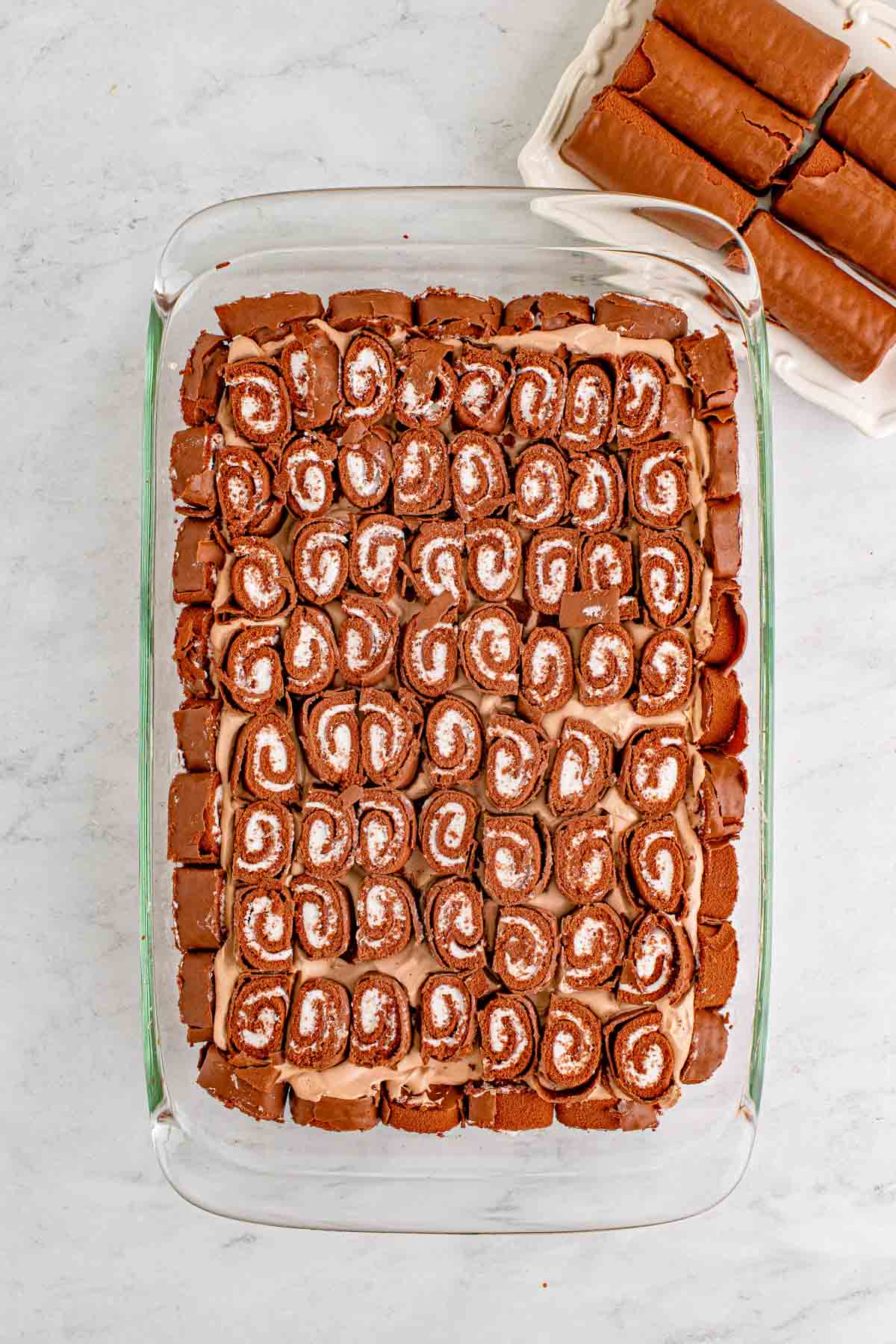 sliced swiss roll cake on top of a cake