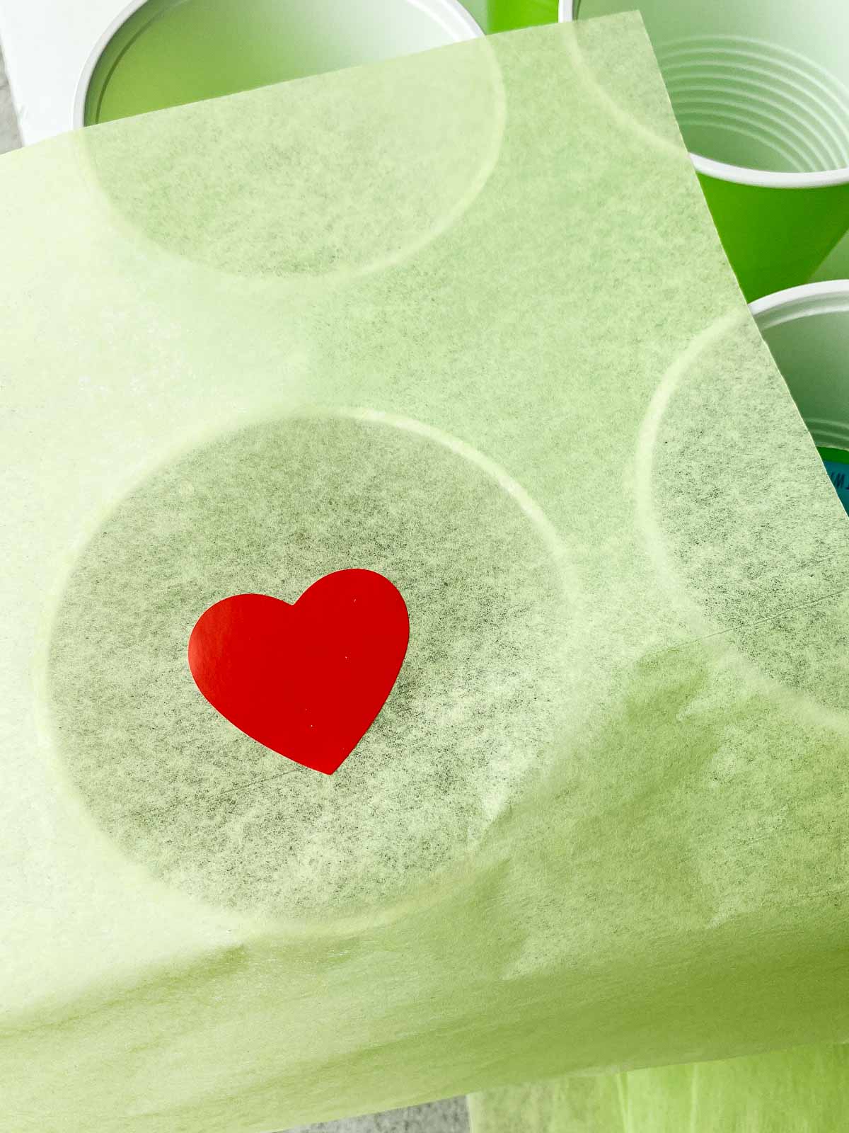 green tissue paper on top of plastic cups