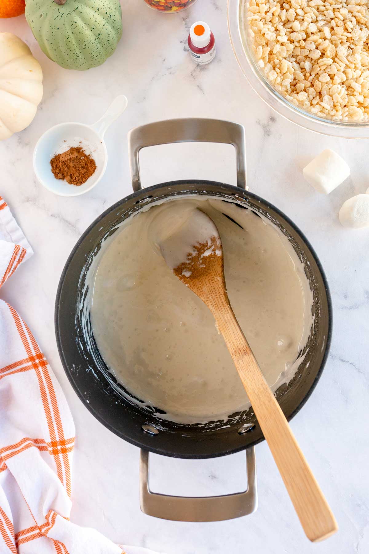 butter and marshmallows melted in a metal pot