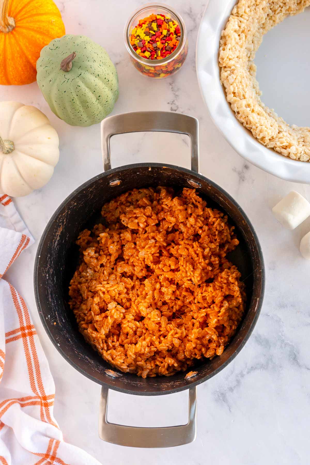 orange rice krispie treats in a metal pan