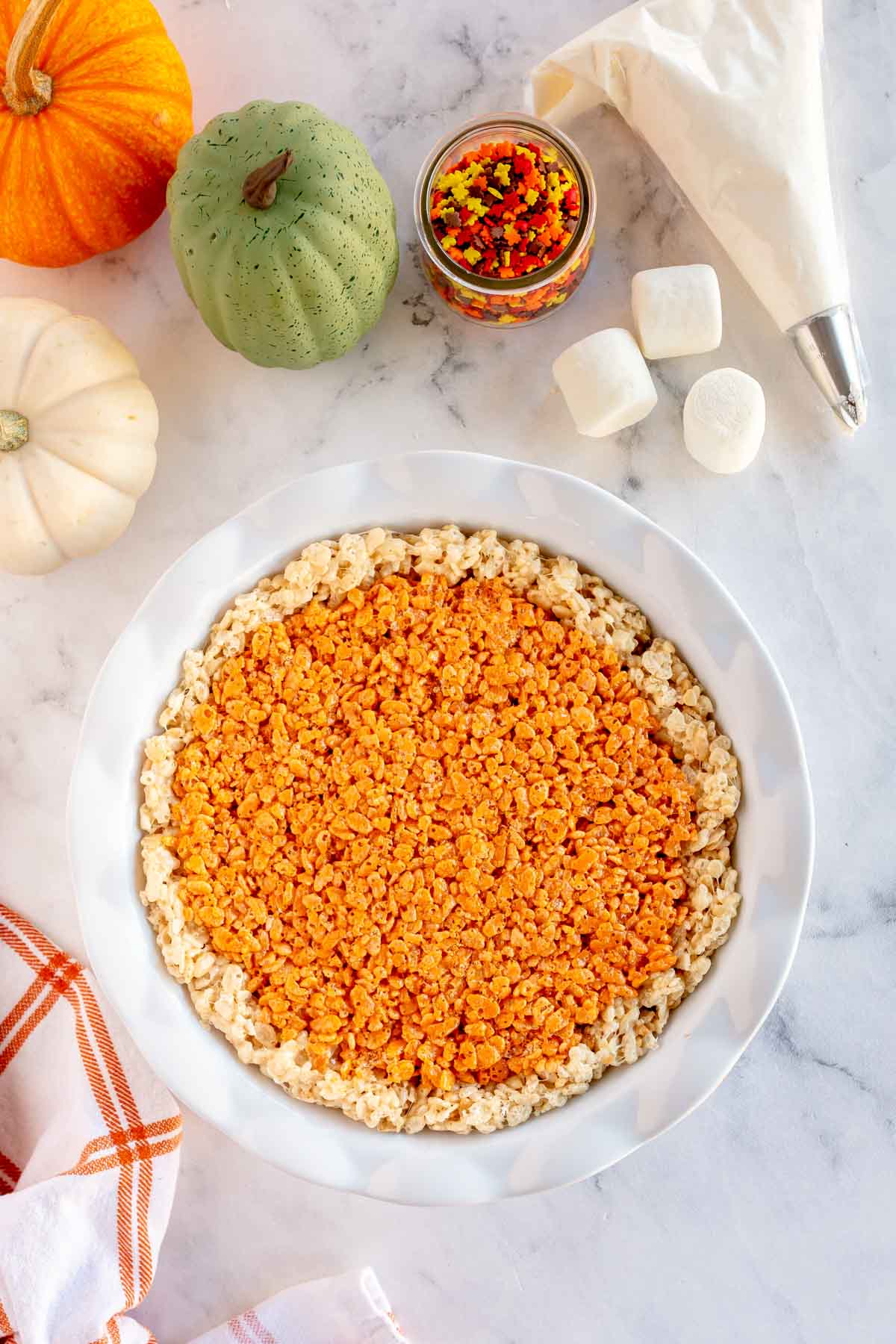 pumpkin pie rice krispie treats in a white pie pan