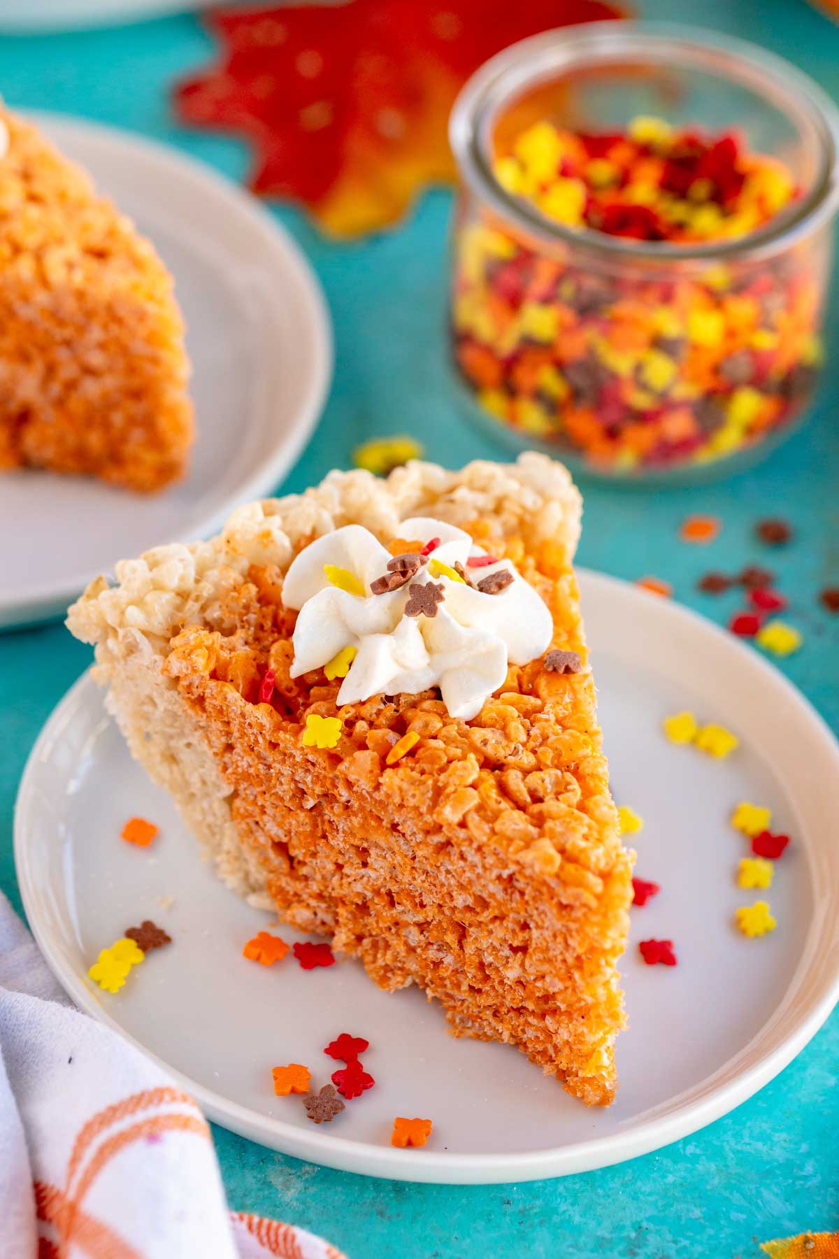 a slice of pumpkin pie rice krispie treats on a white plate