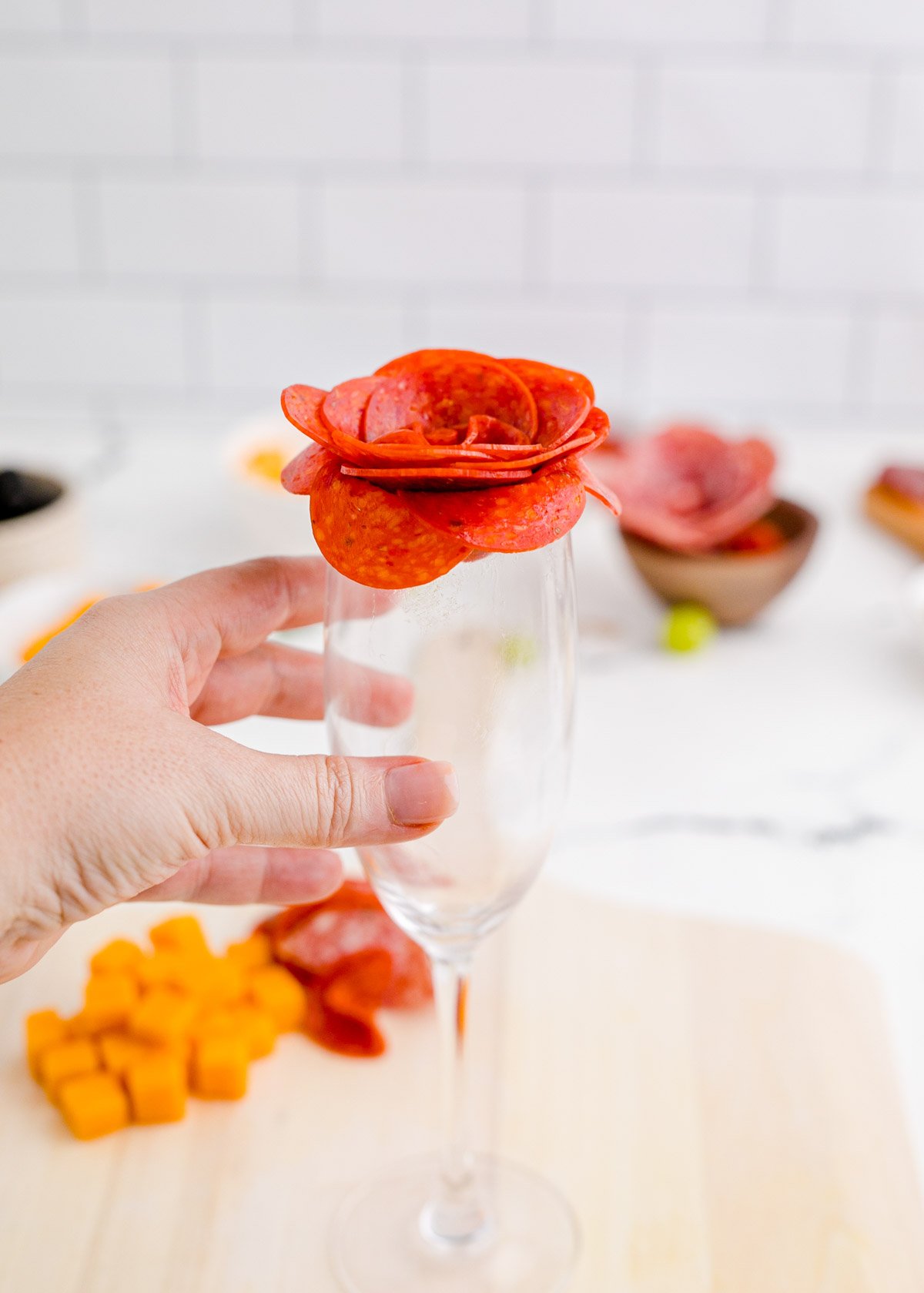 hand holding meat in a glass