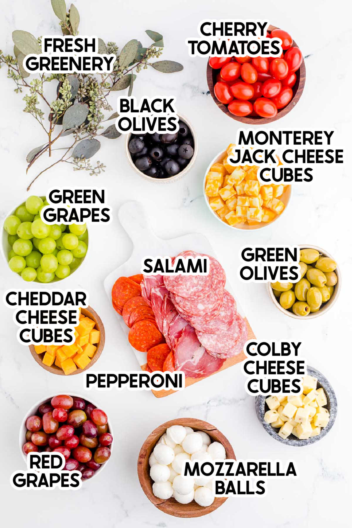 ingredients to make a Christmas charcuterie board with labels