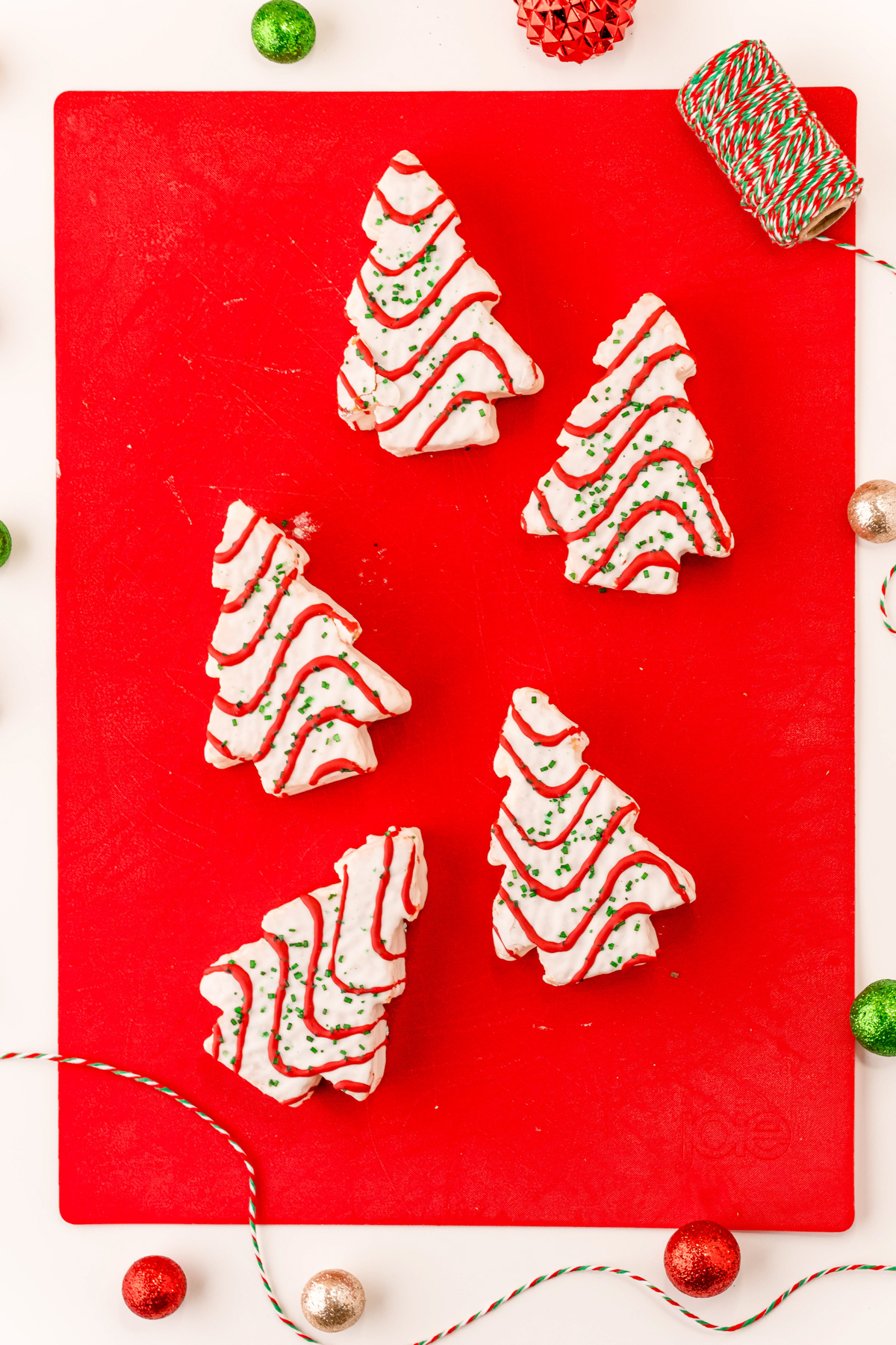 Christmas tree cakes on a red cutting board