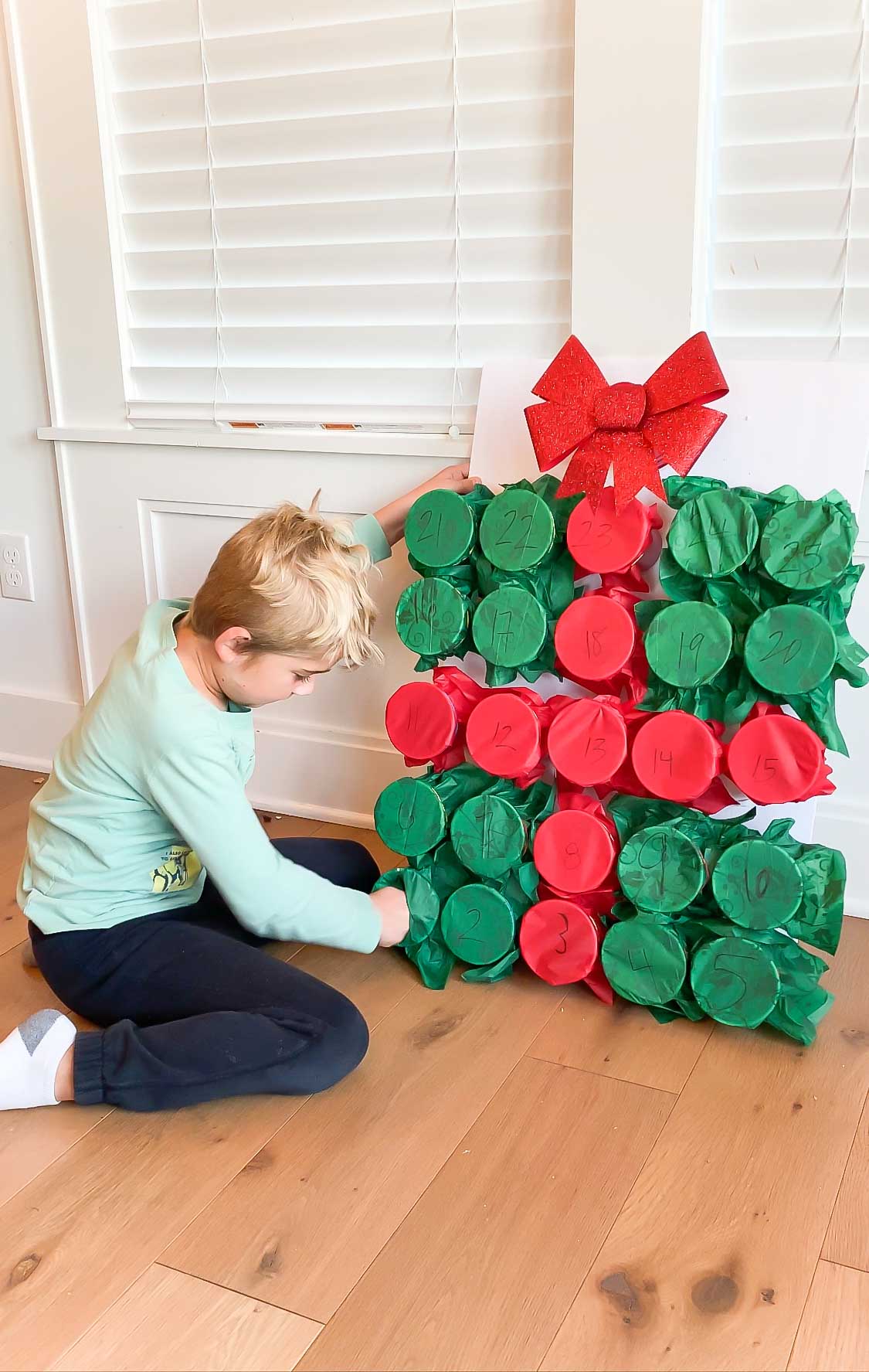 kid punching a DIY advent calendar