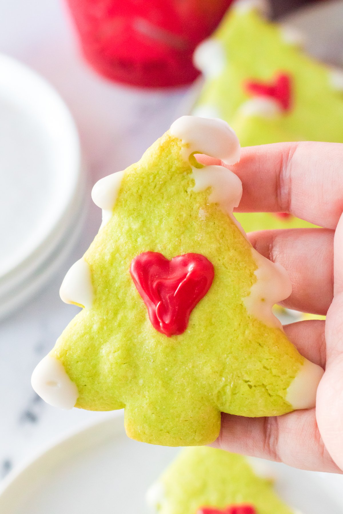 hand holding a Grinch cookie