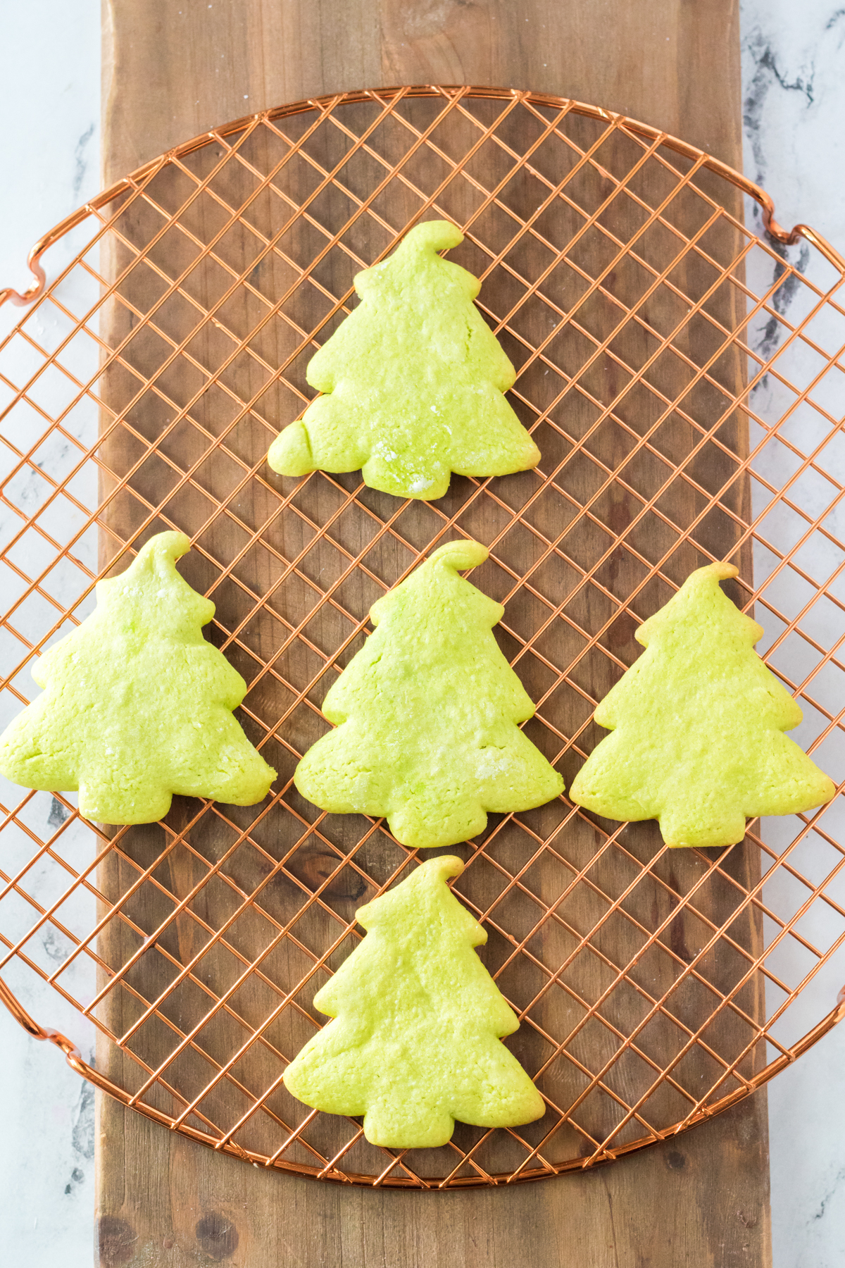 Grinch sugar cookies on a wire rack cooling