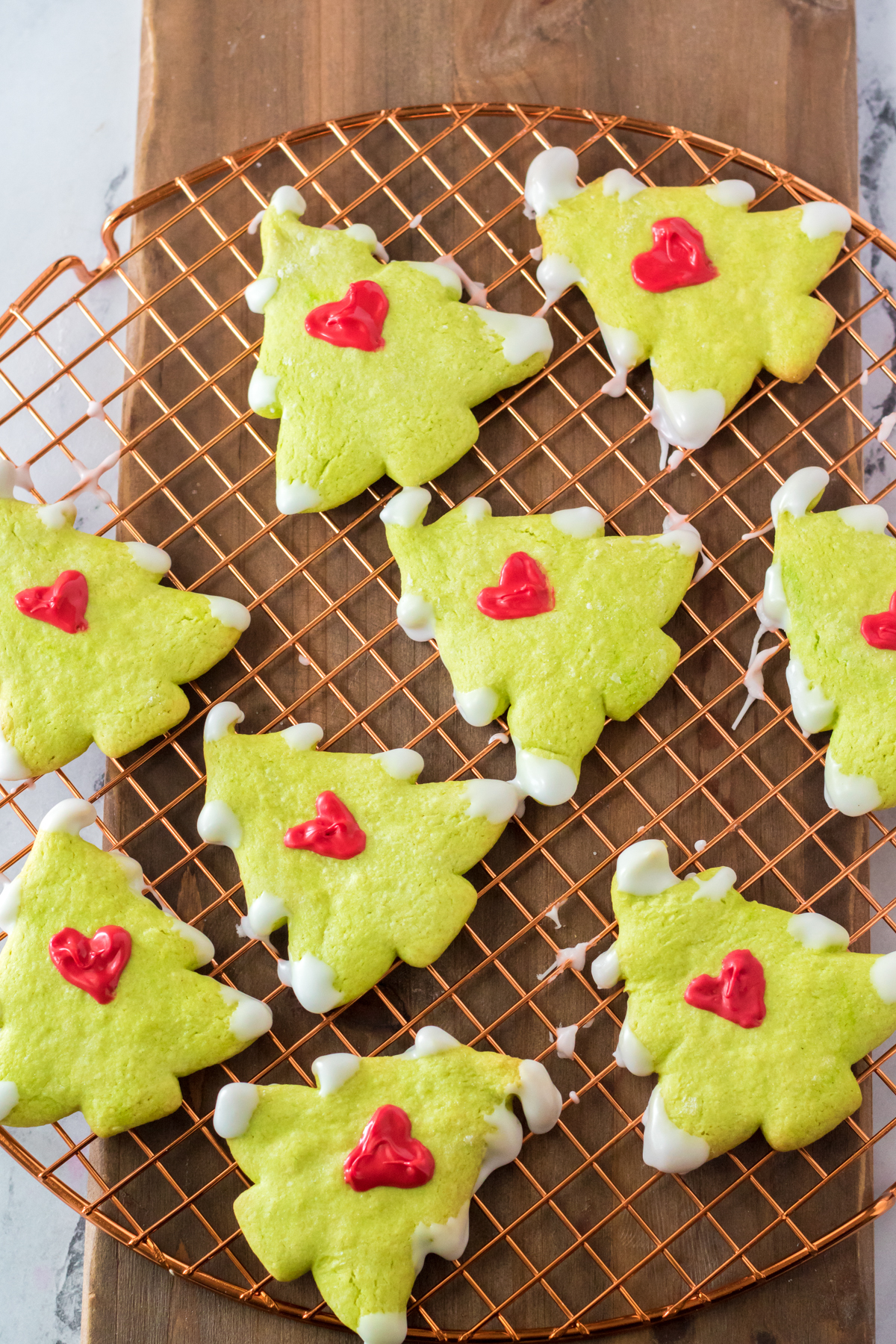 Grinch cookies cooling on a cooling rack