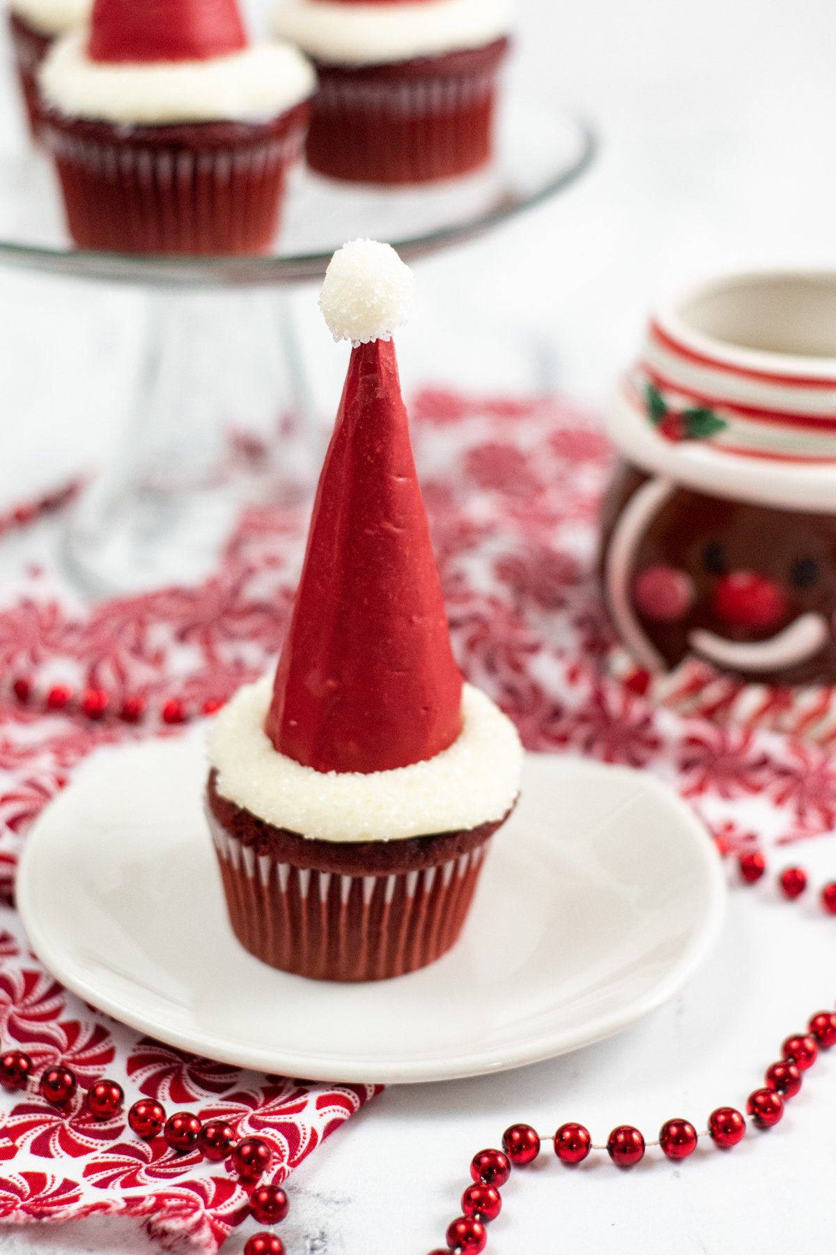 santa hat cupcakes on white plates