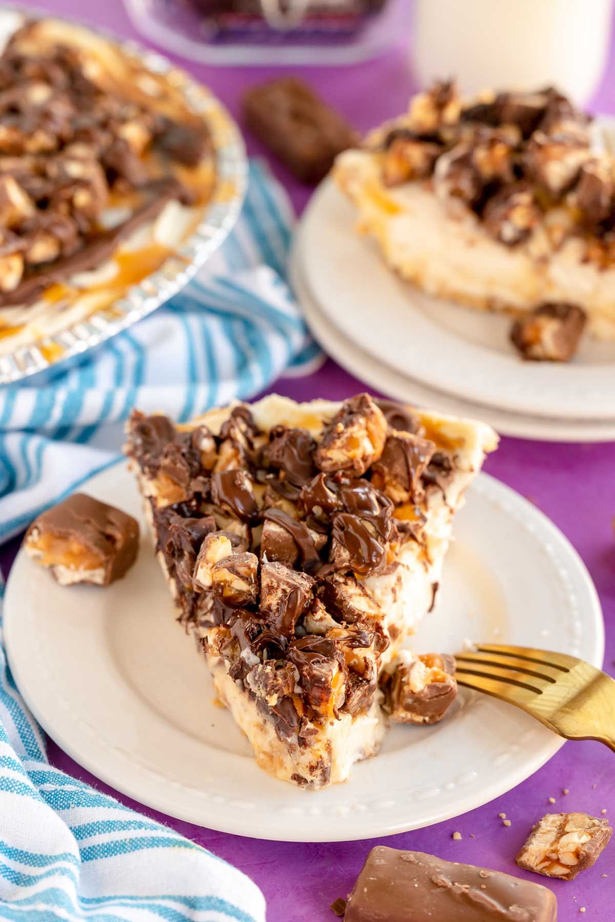 slice of no bake snickers pie on a white plate