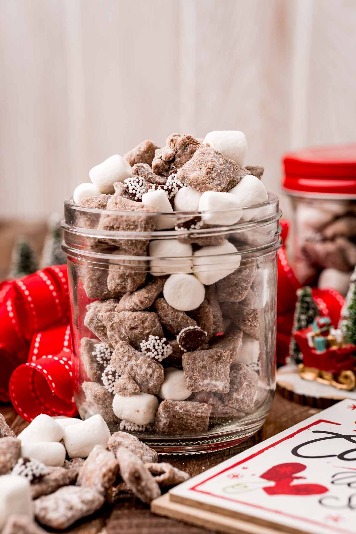 glass jar filled with Christmas muddy buddies