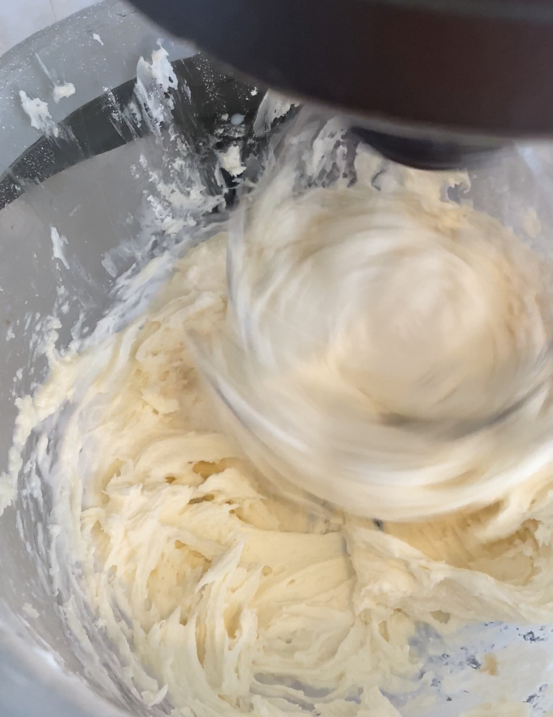 beating buttercream in a mixer