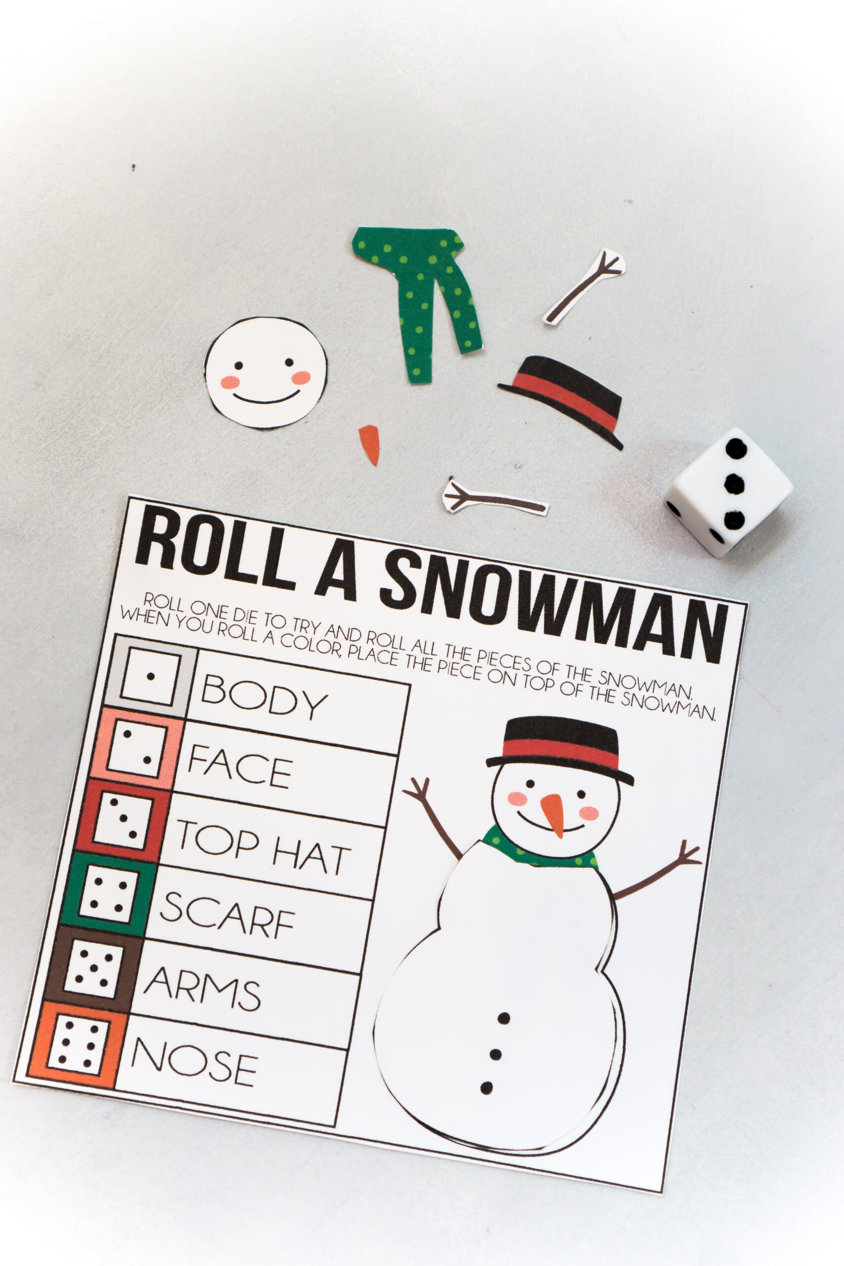 printed out roll a snowman game and pieces