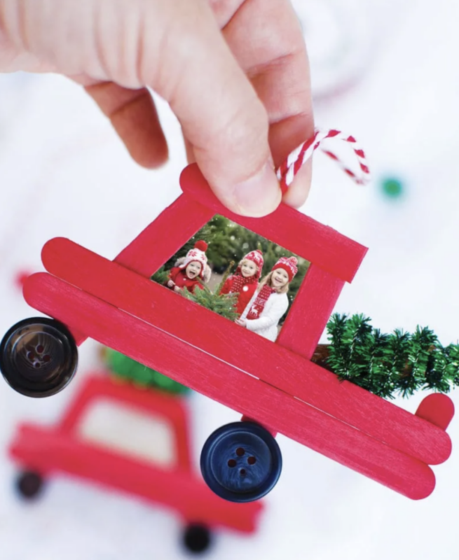 hand holding a popsicle stick truck ornament