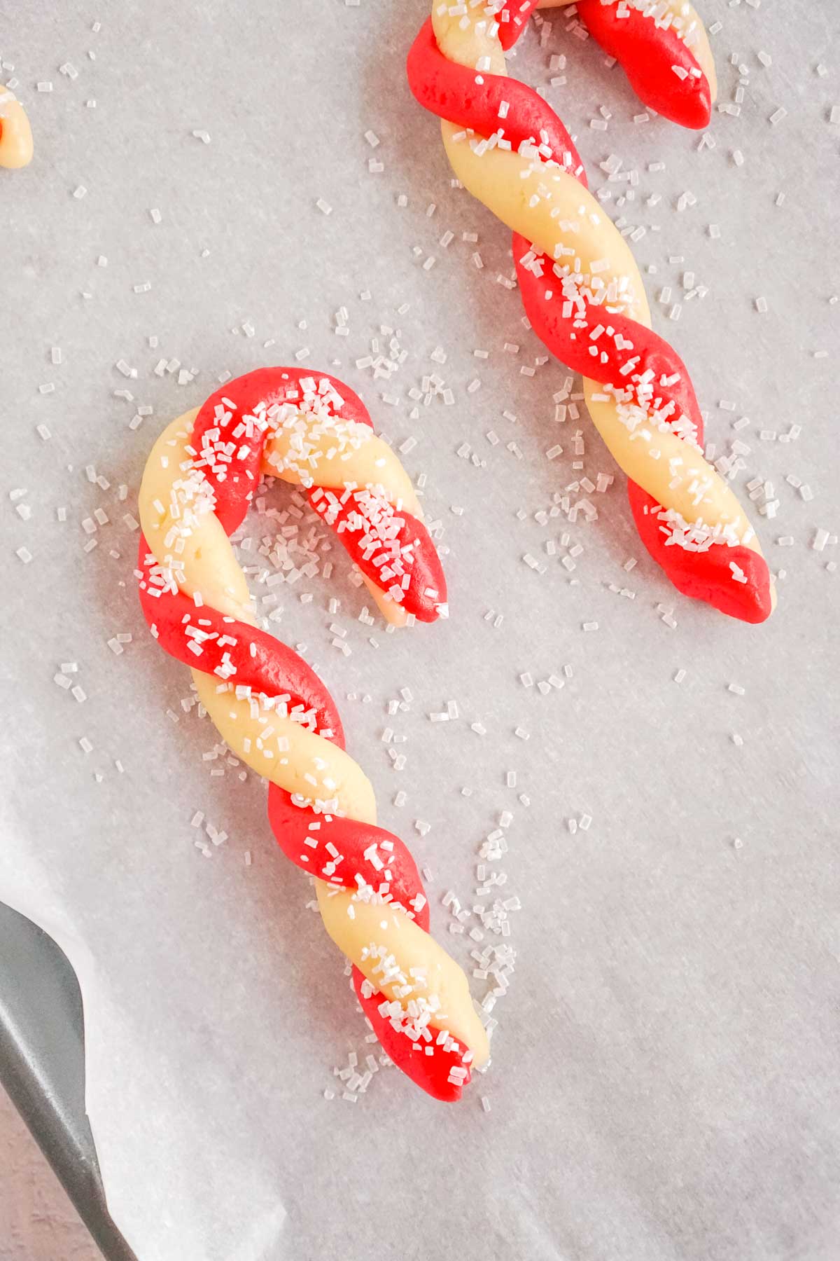 unbaked candy canes sprinkled with sugar