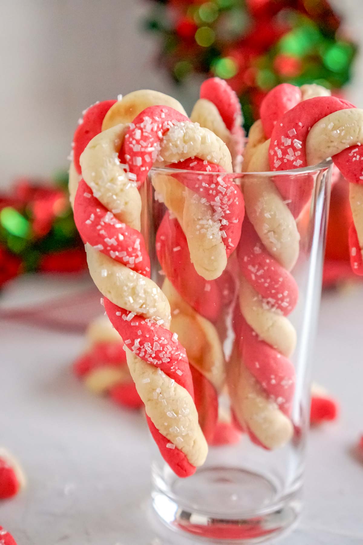 candy cane cookies hanging on a cup