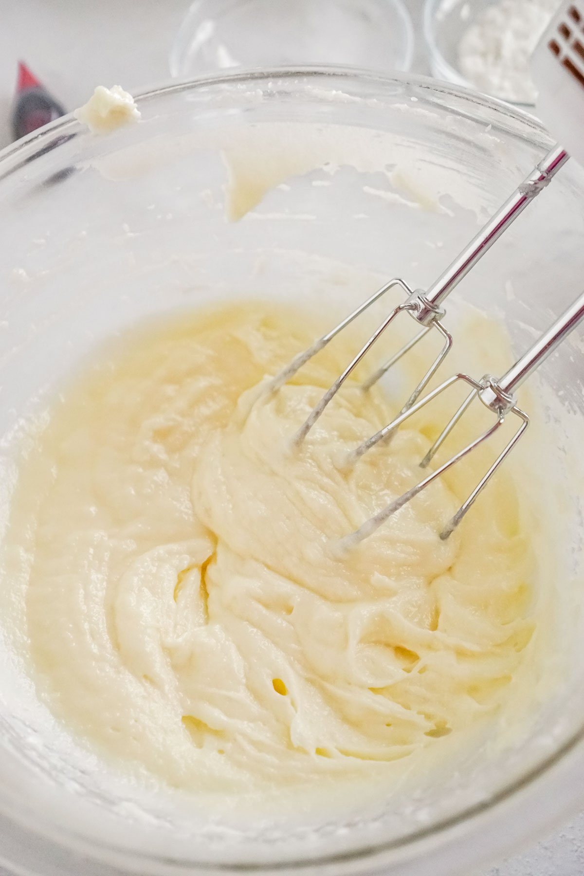 plastic bowl with creamed butter and sugar